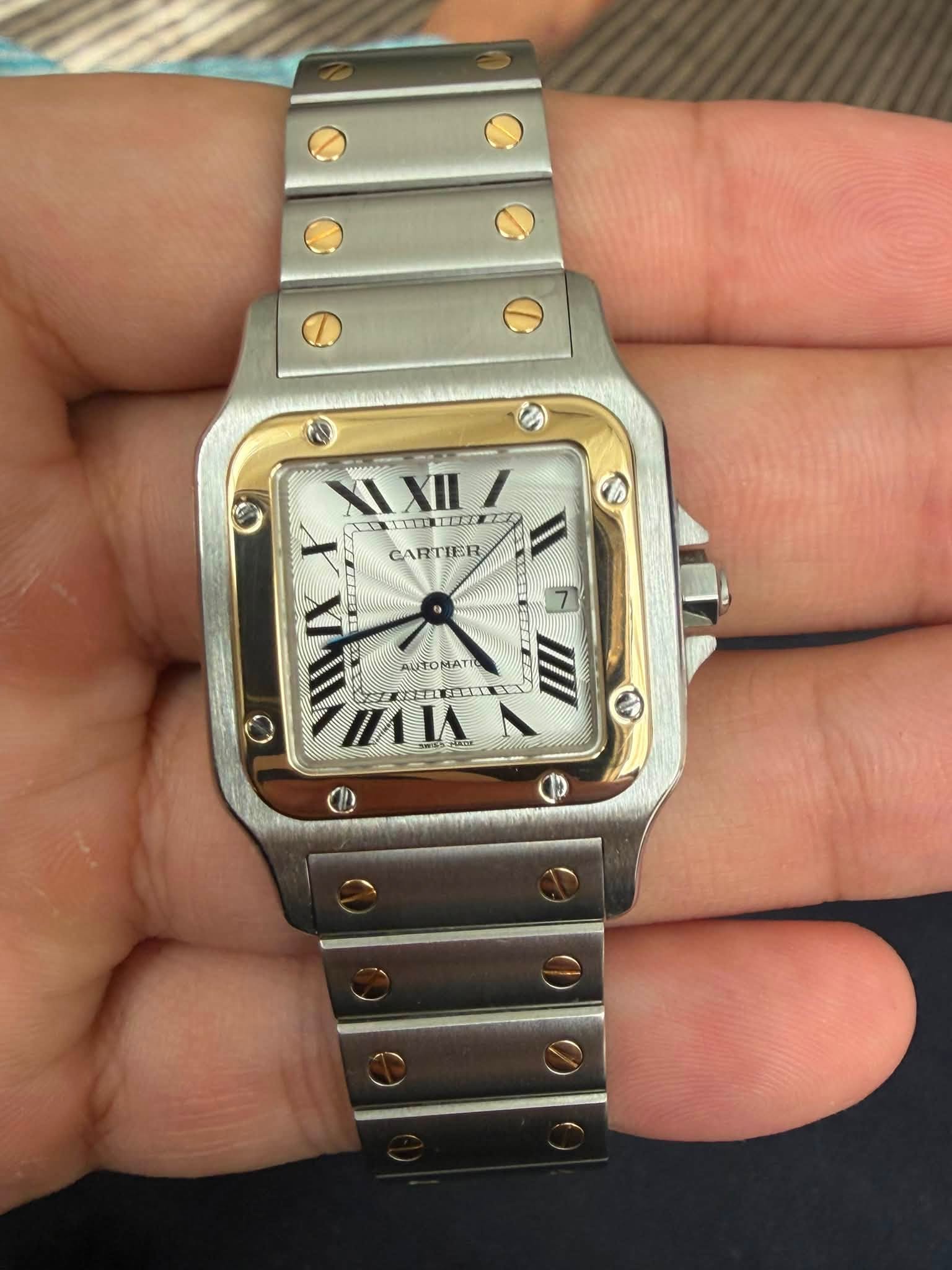 May be an image of wrist watch and text