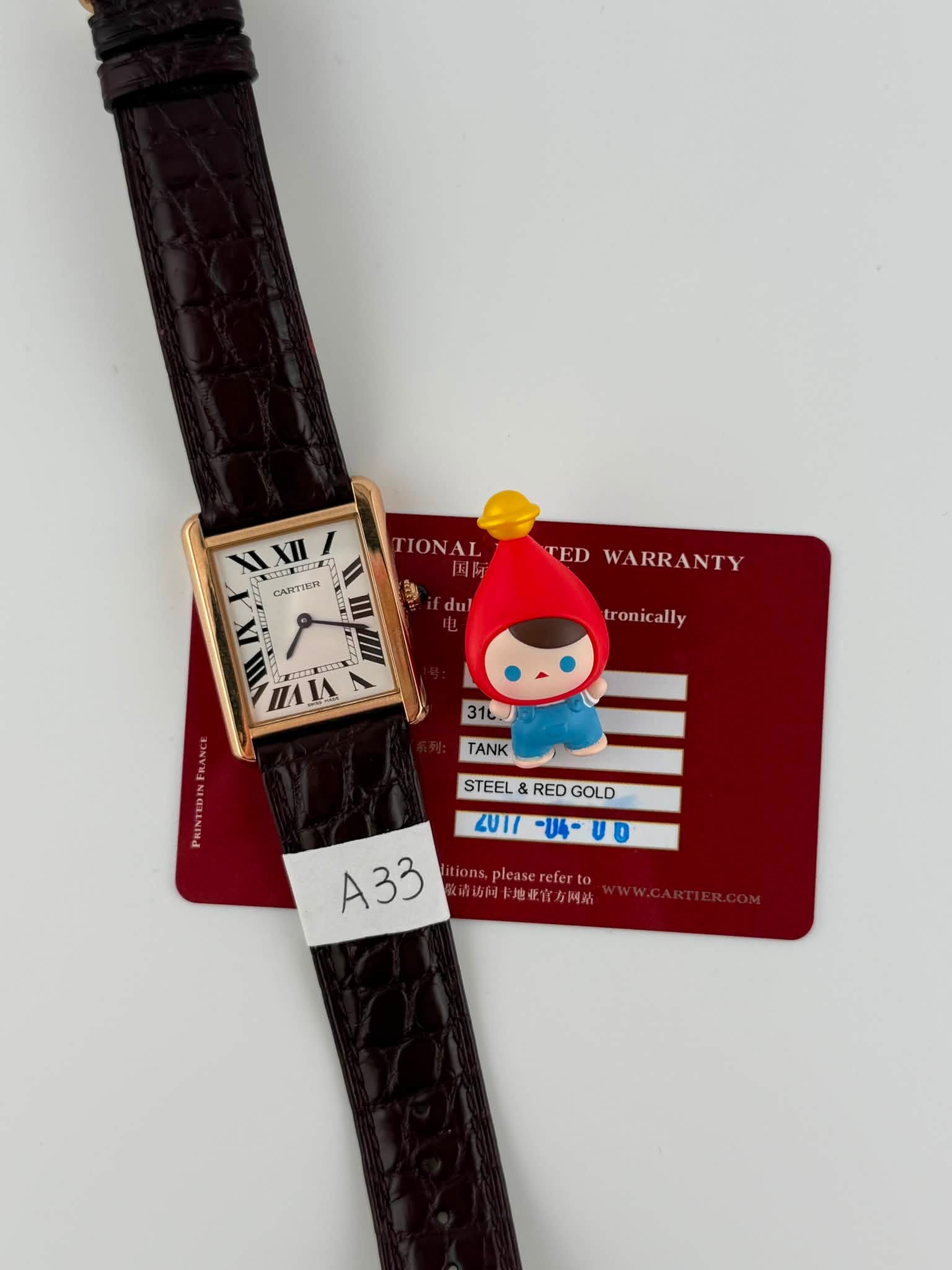 May be an image of digital watch, leather and text that says 'XII CARTIER TIONAL 8 du TED WARRANTY ANTY tronically ronic ally つの0業 AЛ A 31LJ TANK STEEL STEEL&REDGOLD RED GOLD 2UI1…