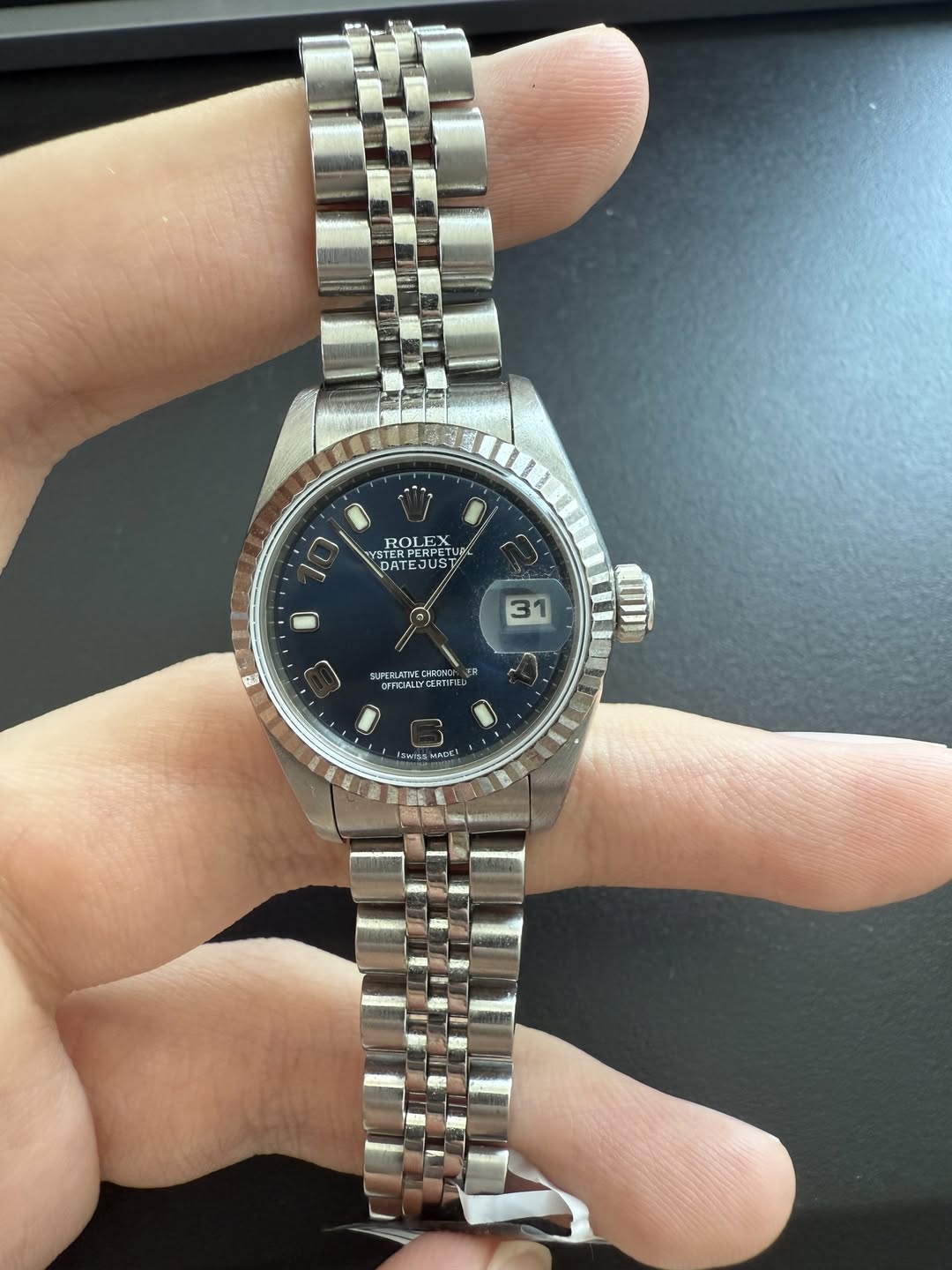 May be an image of wrist watch and text