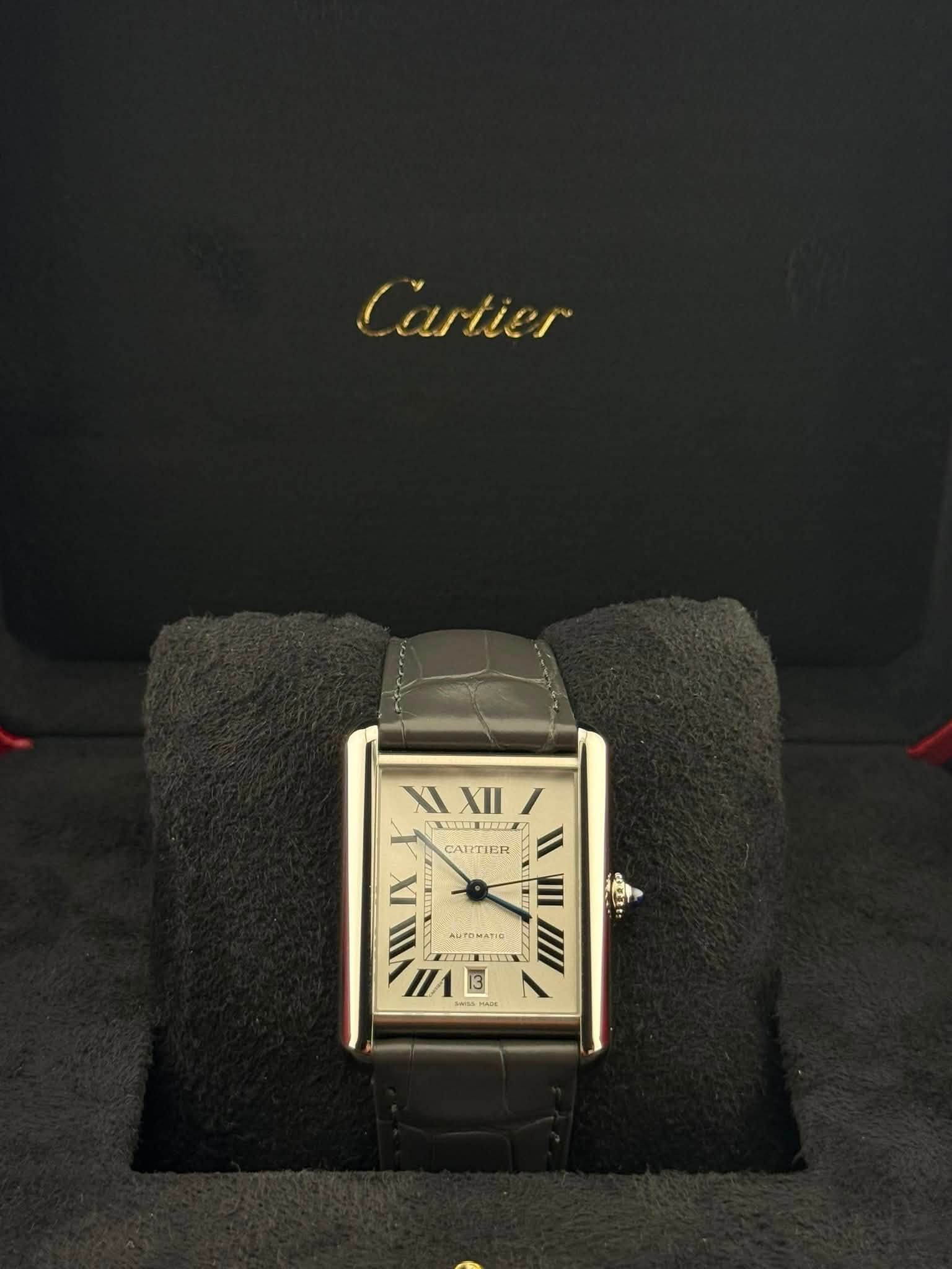May be an image of wrist watch and text that says 'Cartier XIXII/ XI XII XII NAUX CARTIER IX 三 VIII II ETTNI AUTDMATIO ミ 1/1E'