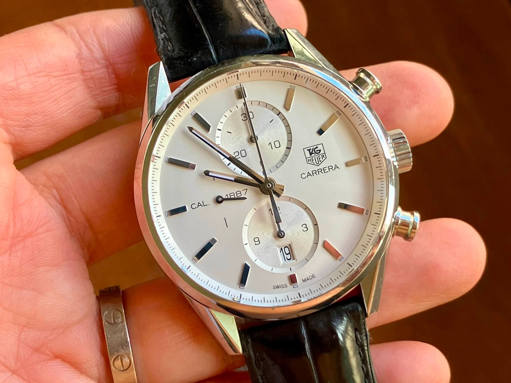 May be an image of wrist watch and text that says 'יןי 3 10 20 TG HETER CARRERA = ማማው CAL. MADE SWISS 0'