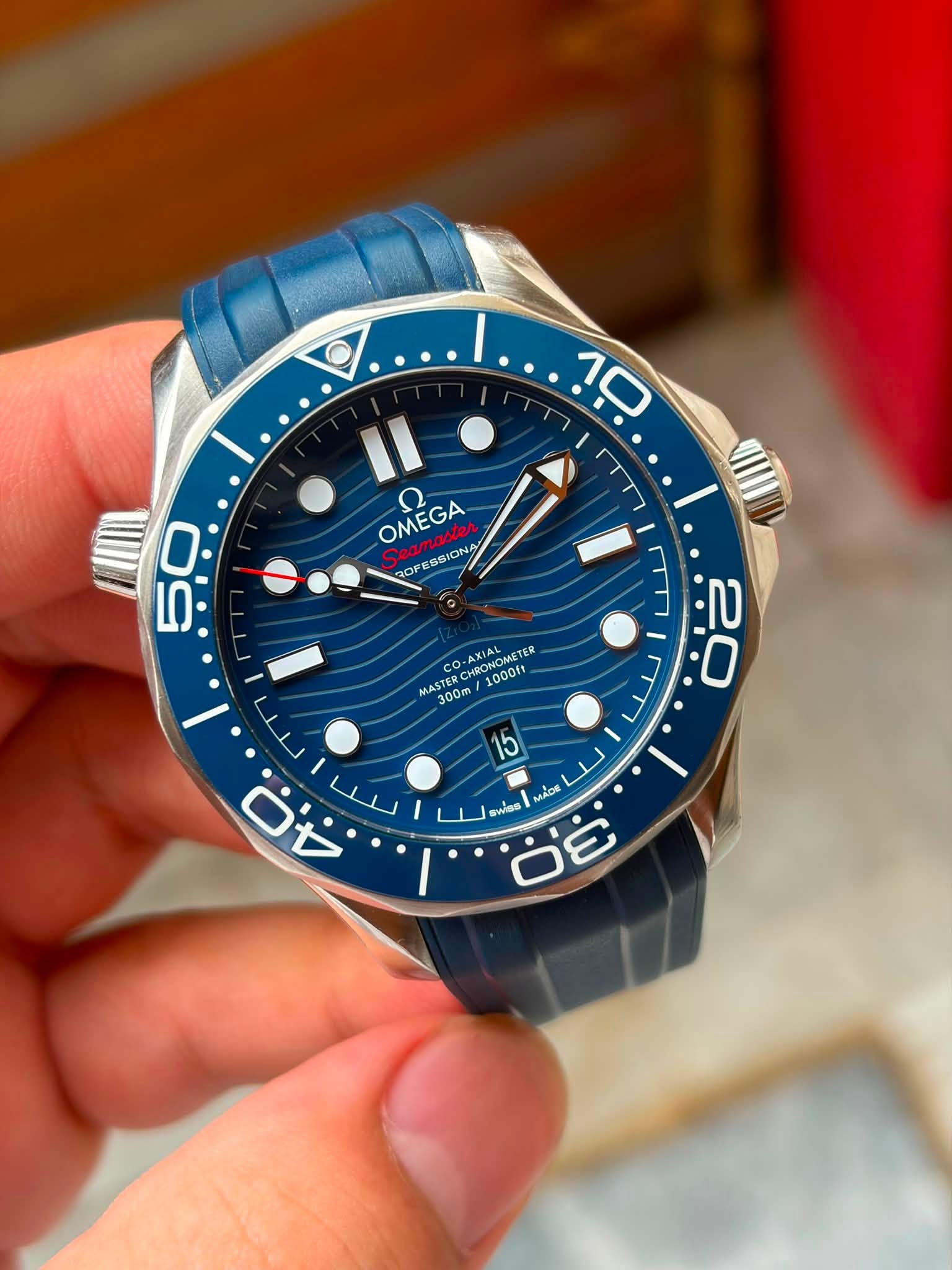 May be an image of wrist watch and text that says '10 OMEGA ONA OMEGA ROP SSION ESSIC 50 9 0 AXIAL CHRONOME RONOMETER TER MASTER TER co MAS 1000ft 300m 20 O 2 / 15 Y MACE MADE…