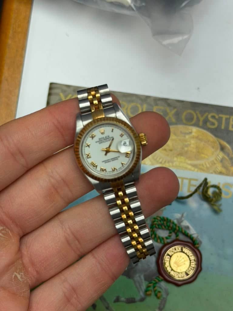 May be an image of wrist watch and text