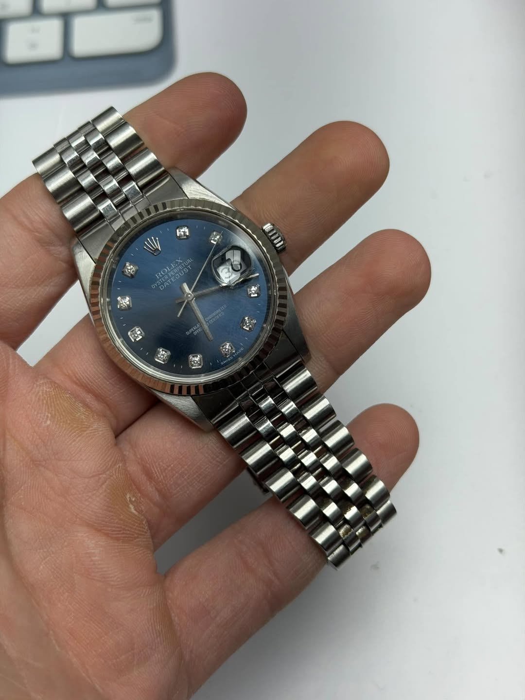 May be an image of wrist watch and text