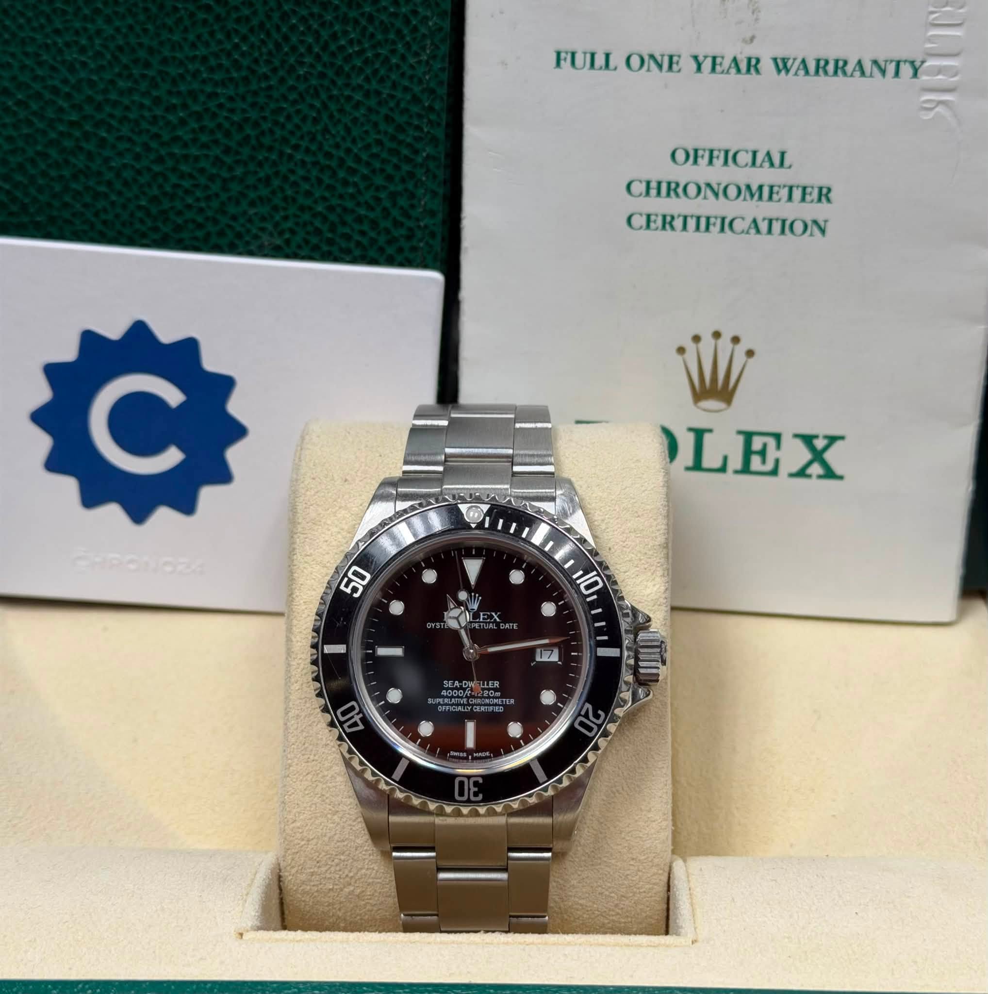 May be an image of wrist watch and text that says 'FULL ONE YEAR WARRANTY OFFICIAL CHRONOMETER CERTIFICATION c LEX فی'