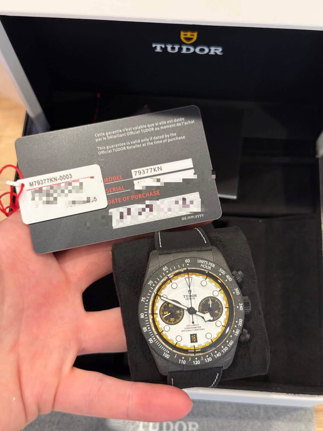 May be an image of wrist watch and text that says 'TUDOR que sielleest Felleestdatée l'achat momentd garantle UDORS parte Détailiant Retailer validon atthe the time itdated…