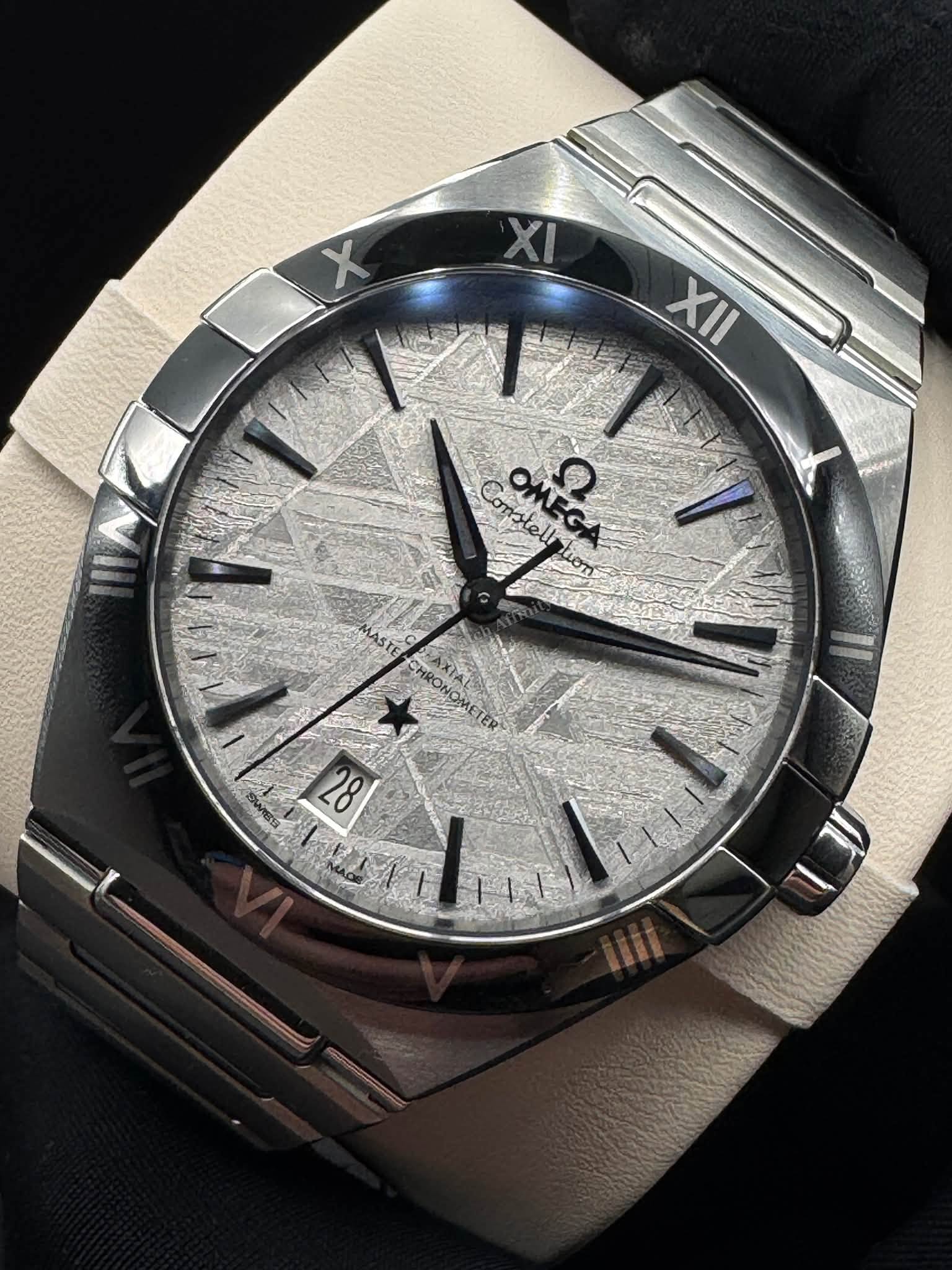May be an image of wrist watch and text that says 'X XII Constell ይዝ ASTE E 28'