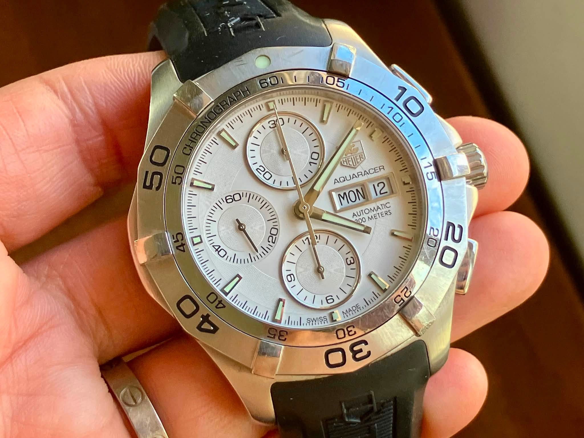 May be an image of wrist watch and text that says '60บ 1051 ושיייוייויין ጥርርጣ D 30 יויייןייישייין 0 D יוייויייויין οι HEUER AQUARACER MON 12 AUTOMATIC METERS G 20 mlintia 20 2 6…