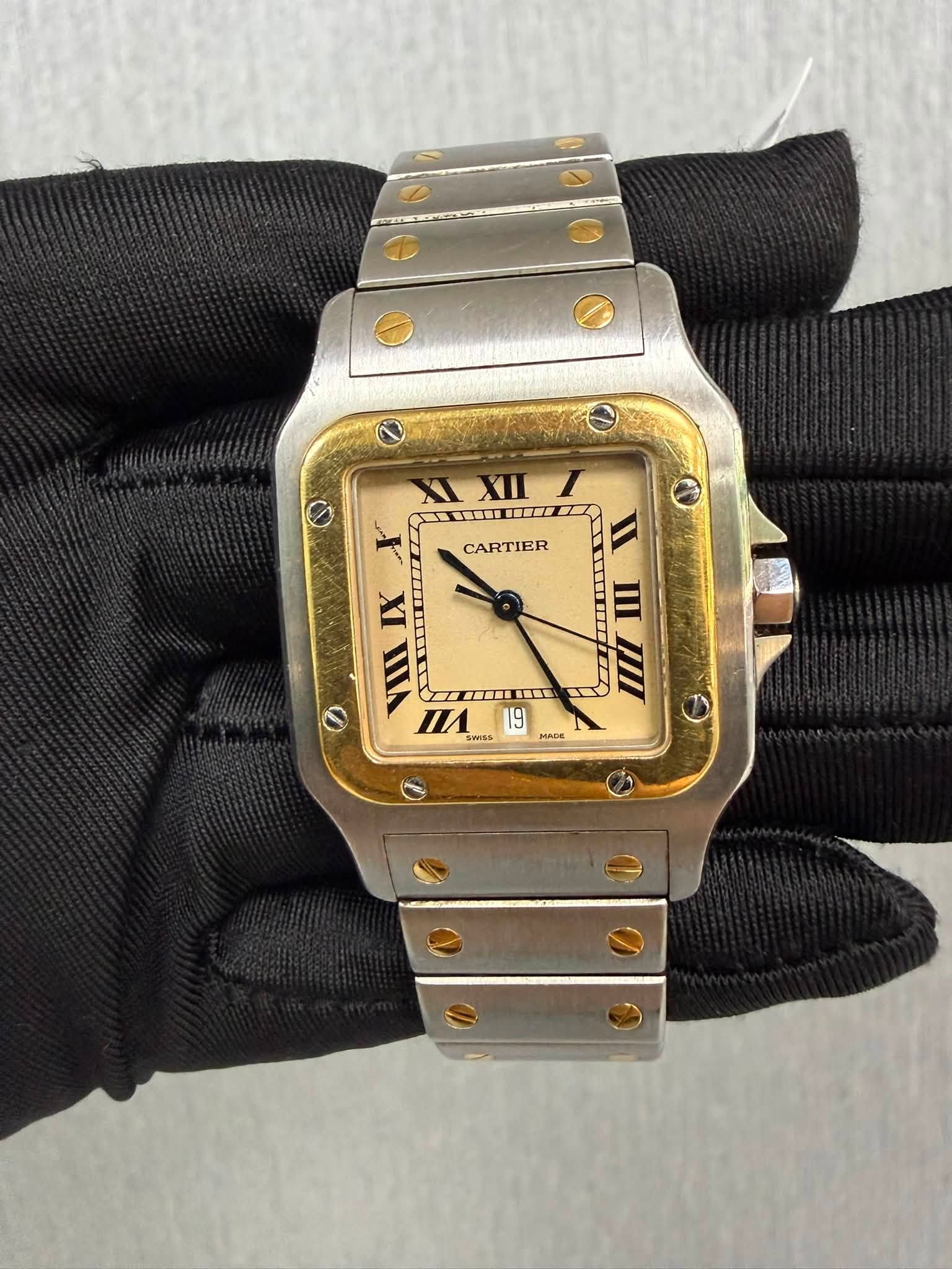May be an image of wrist watch and text that says 'XI XIXII TI I CARTIER IX VIII TTIMLM T SWISS 19 MADE ADE И I mI IIIII III W O'
