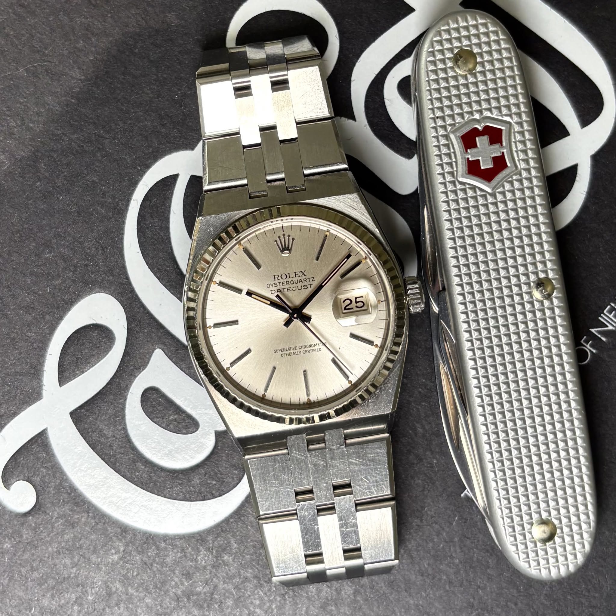 May be an image of knife, wrist watch and text
