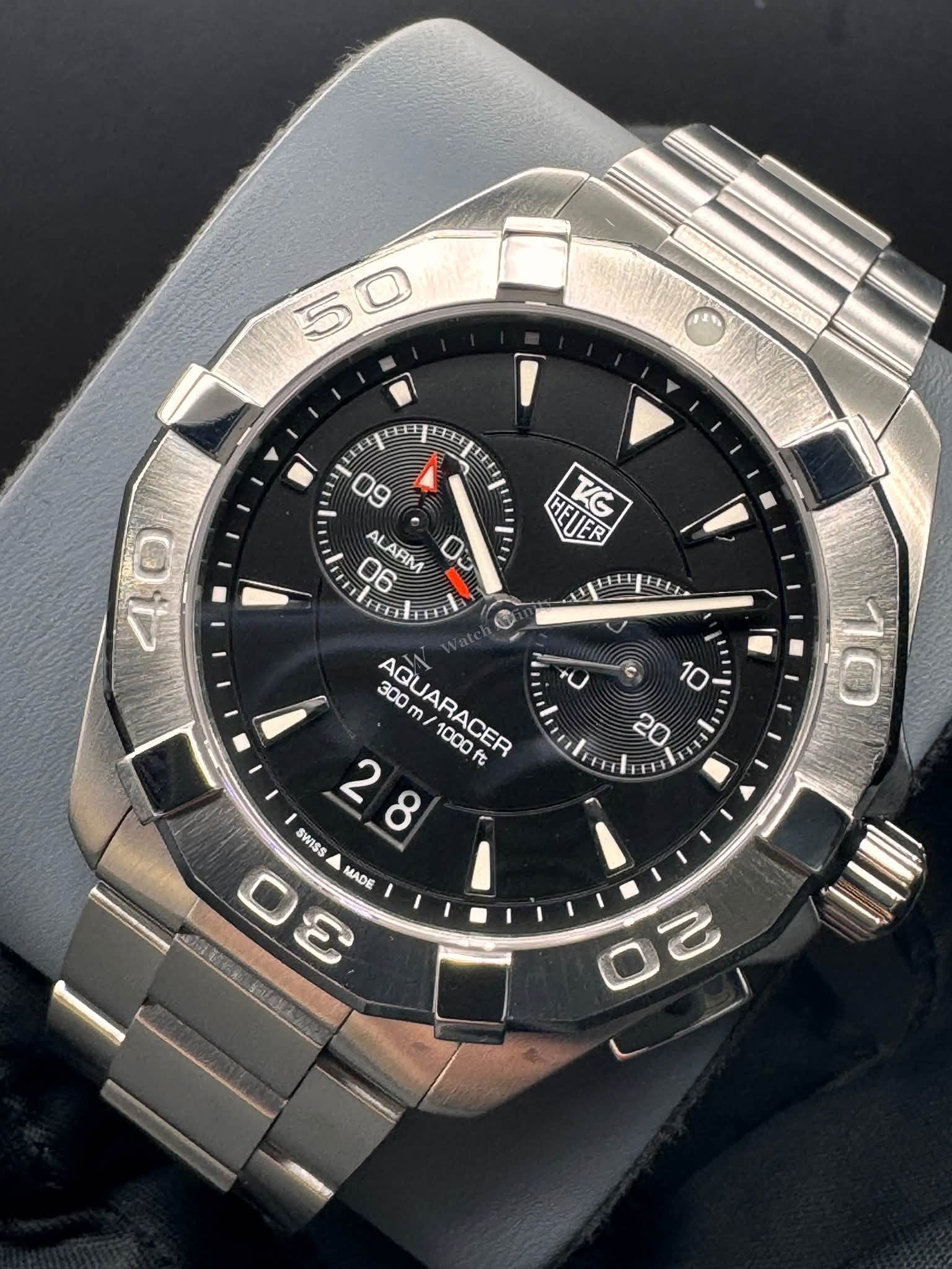 May be an image of digital watch and text that says '5 50 田 09 06 LARM 03 HELIER TG 40 O ٢ AQUARACER ACER 1000 代 1 SWISS 28 2 8 Θε O MADE 10 10'