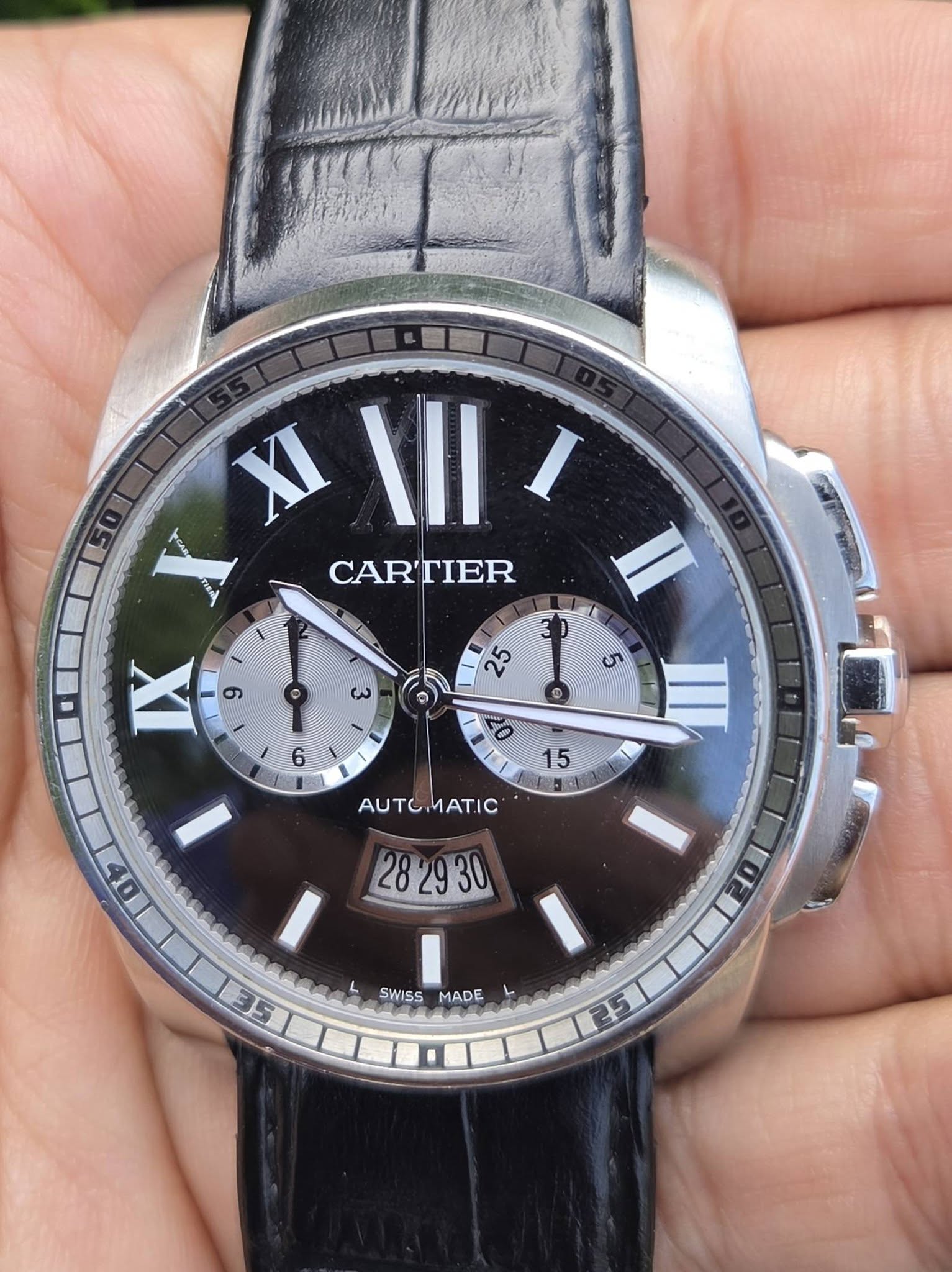 May be an image of wrist watch and text