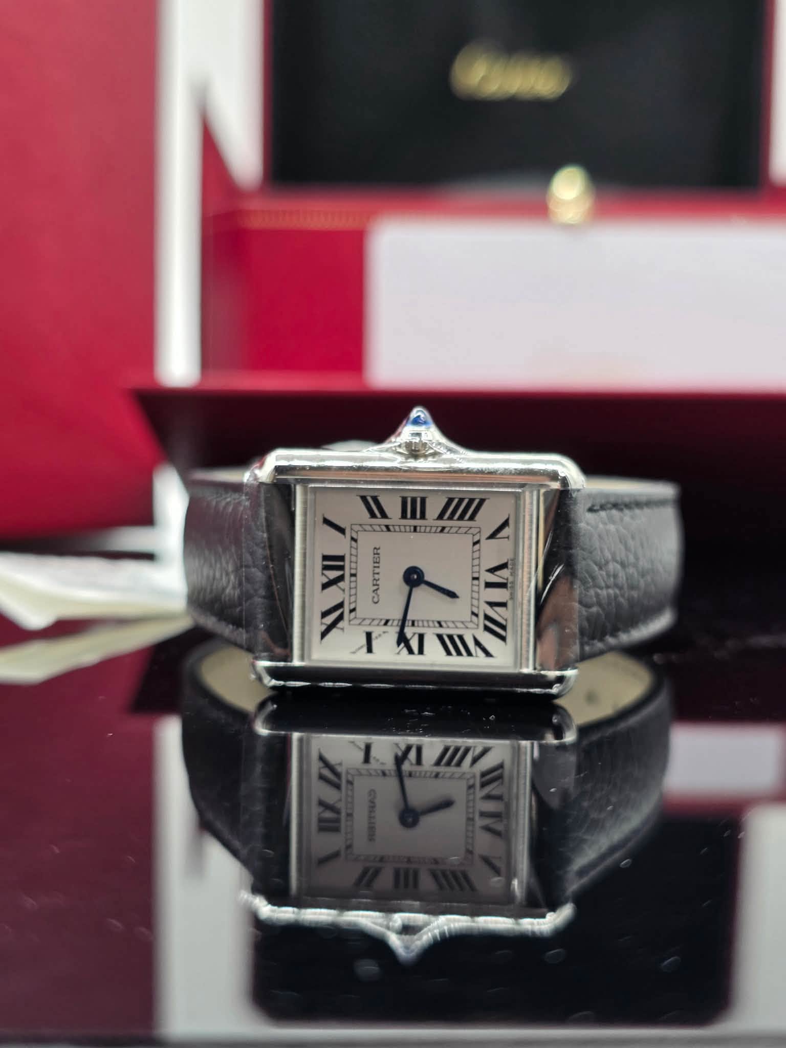May be an image of wrist watch and text