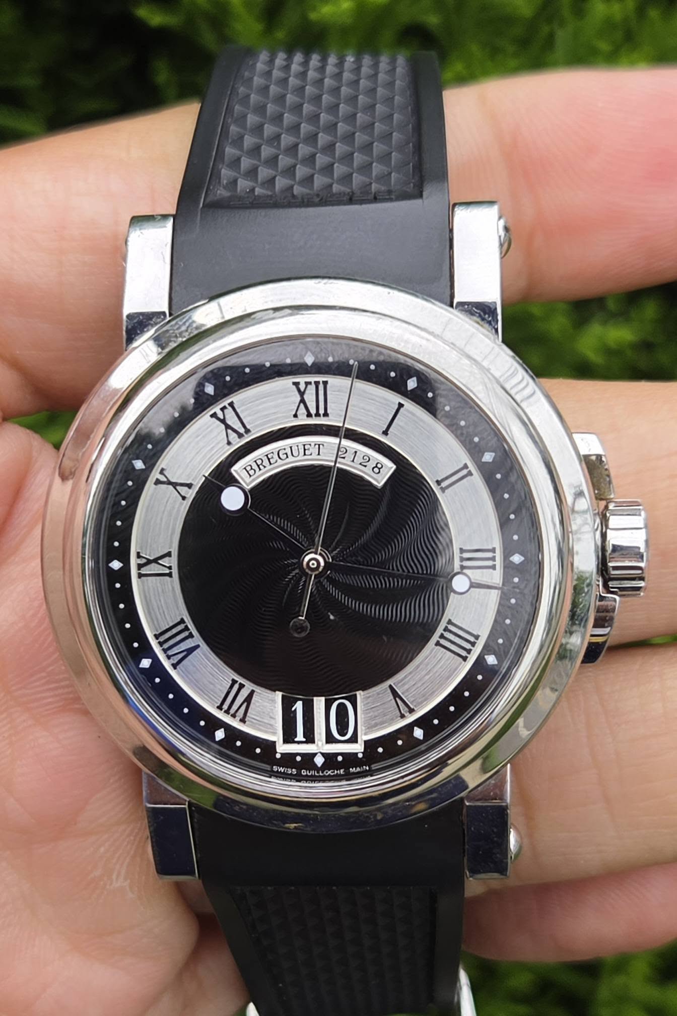 May be an image of digital watch and text that says 'II XI XII X BREGUET 2128 8 I IX VIII VII 10 III III SWISS GUIL DUILLOCHE mA MAi'