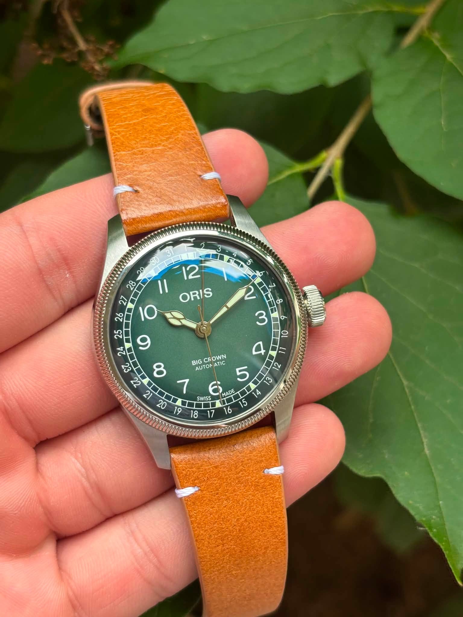 May be an image of wrist watch and text that says ' I1 ORIS 26 27 IO 25 و 24 ει BIG IGCFOWN MyT AUTO ATIC ONATIC AT El 21 τι MAA MADE 1 - V 4 S 16 SWISS T 18 17'