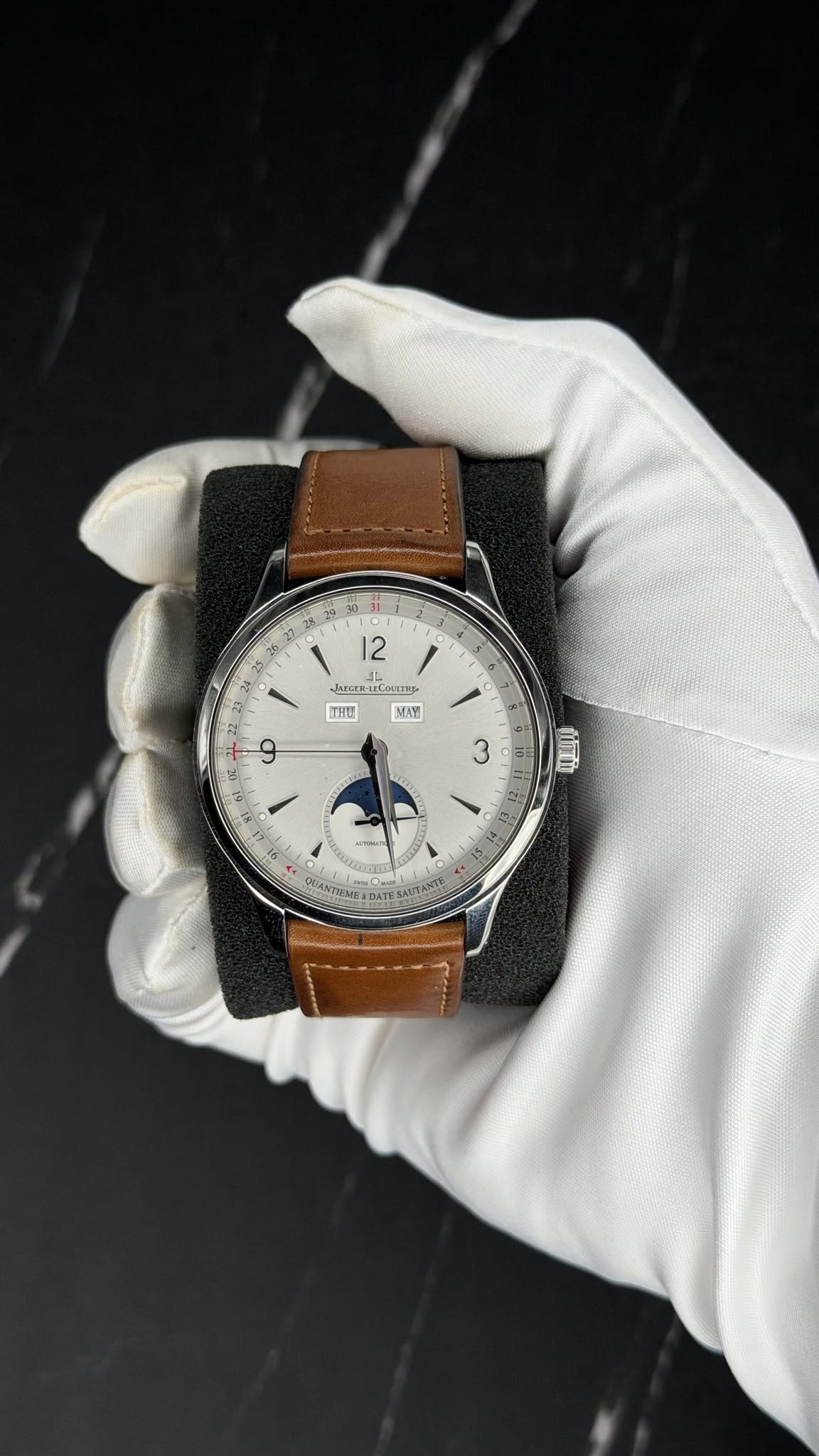 May be an image of wrist watch, leather and text