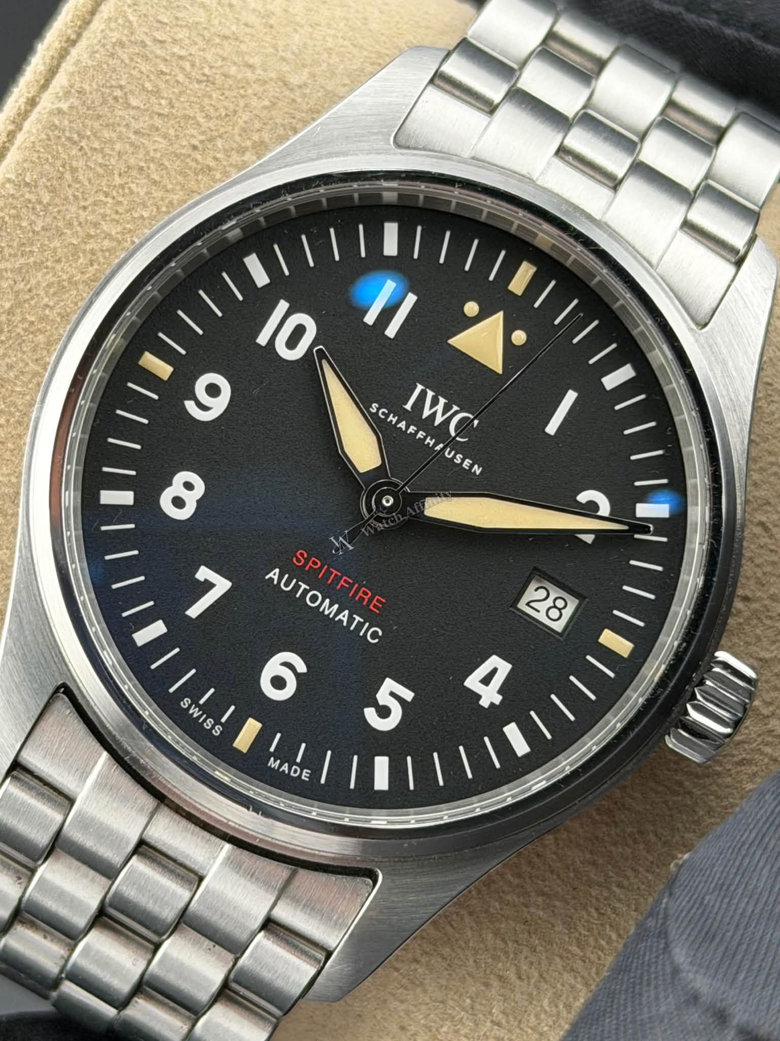 May be an image of wrist watch and text that says '10 II ز 9 HA IWC SCHAFFH/USEN SCHAFFHIUSEN AF AUSEN HA 7 AUTOMATIC SPITFIRE M 28 6 SWISS W S 5 R S MADE'