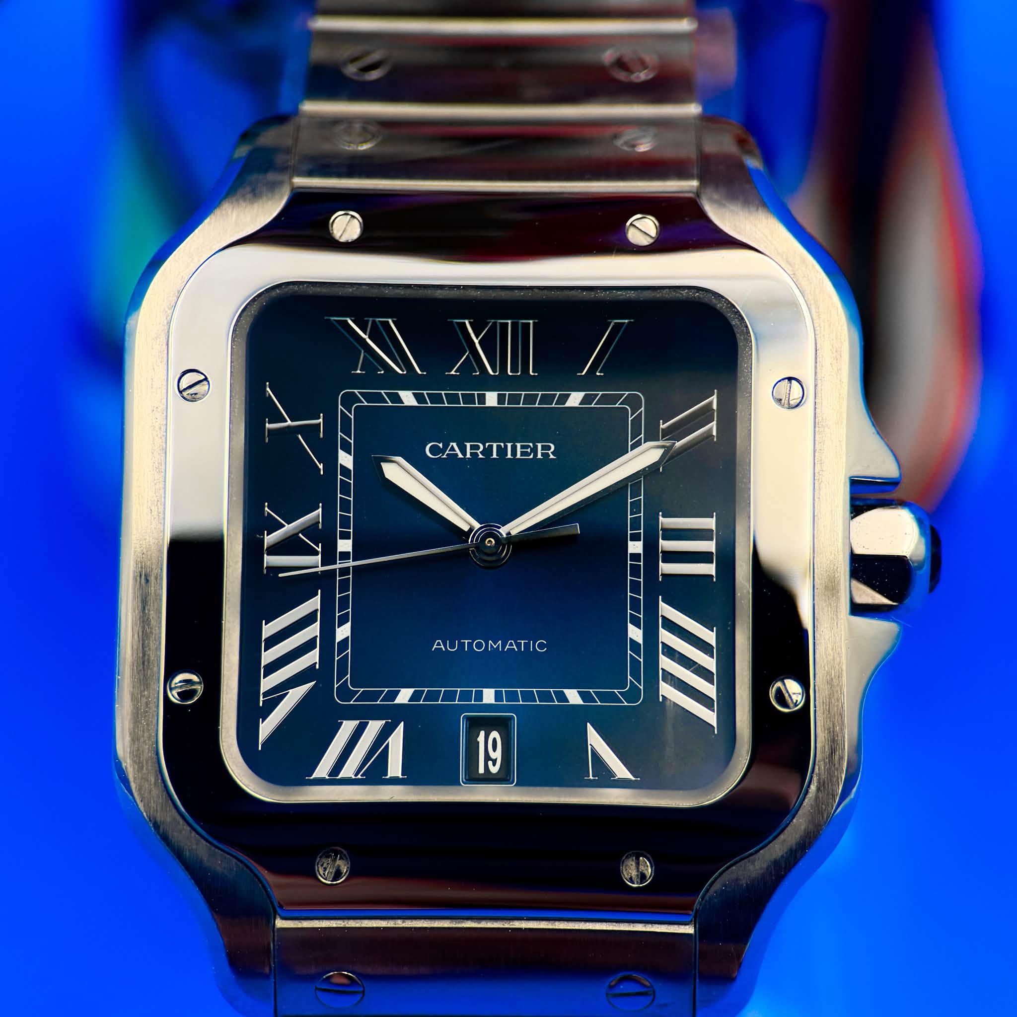 May be an image of digital watch and text that says 'MI XII XXIL/ XII/ I II CARTIER I VIIXY t 外 VIIII и AUTOMATIC 19 / 4'