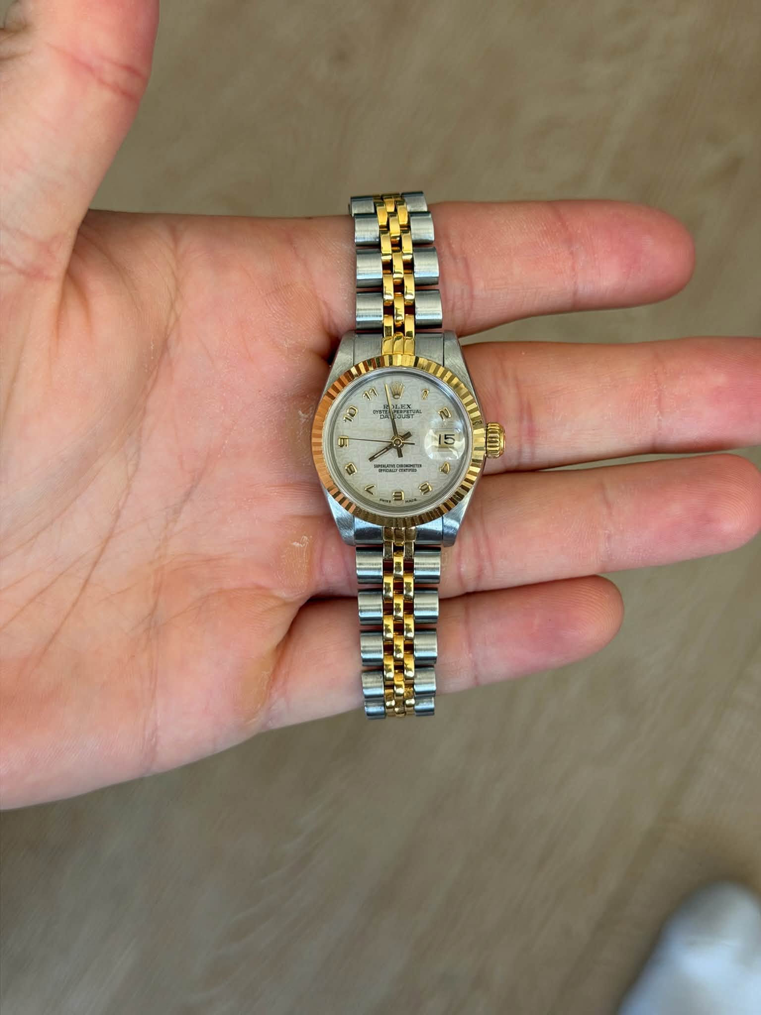 May be an image of wrist watch and text