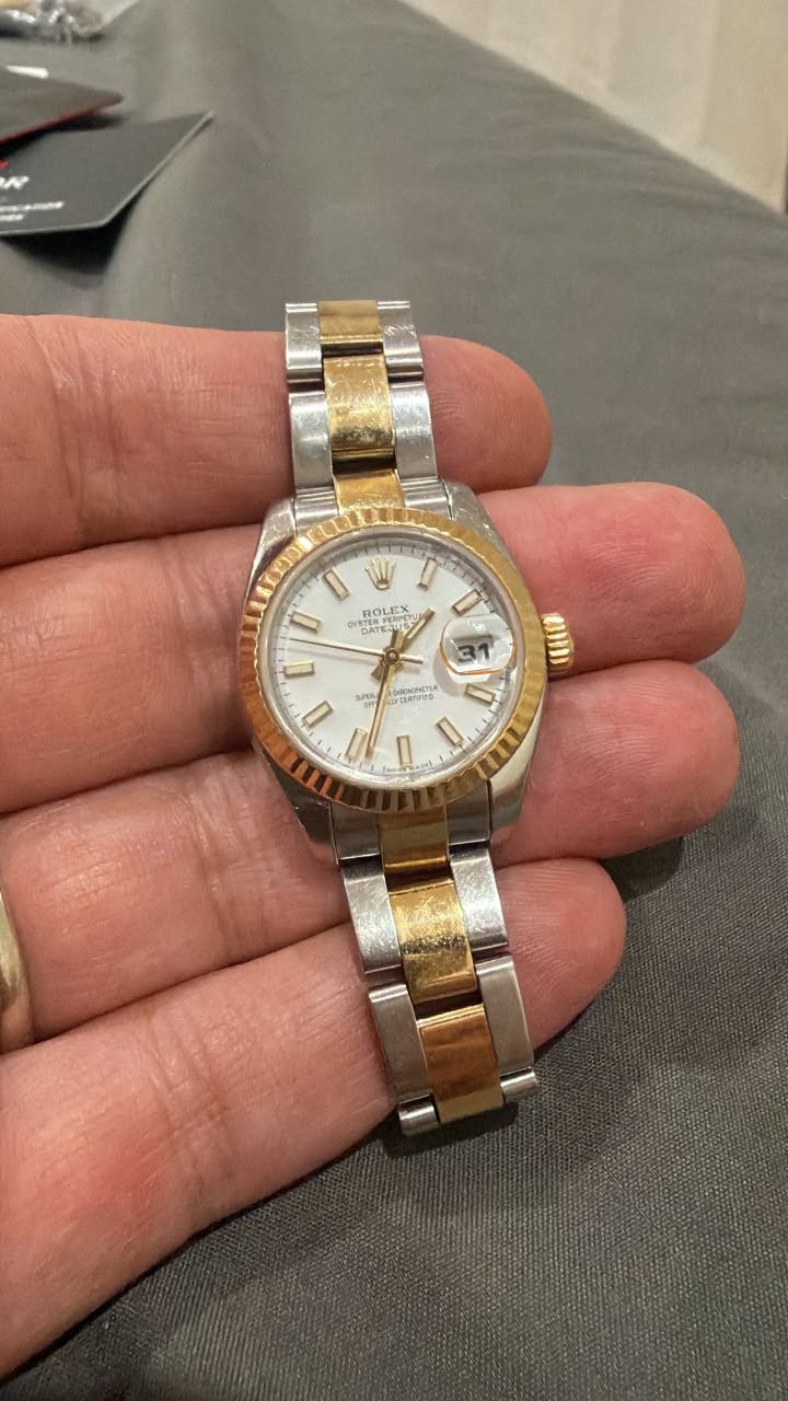 May be an image of wrist watch and text