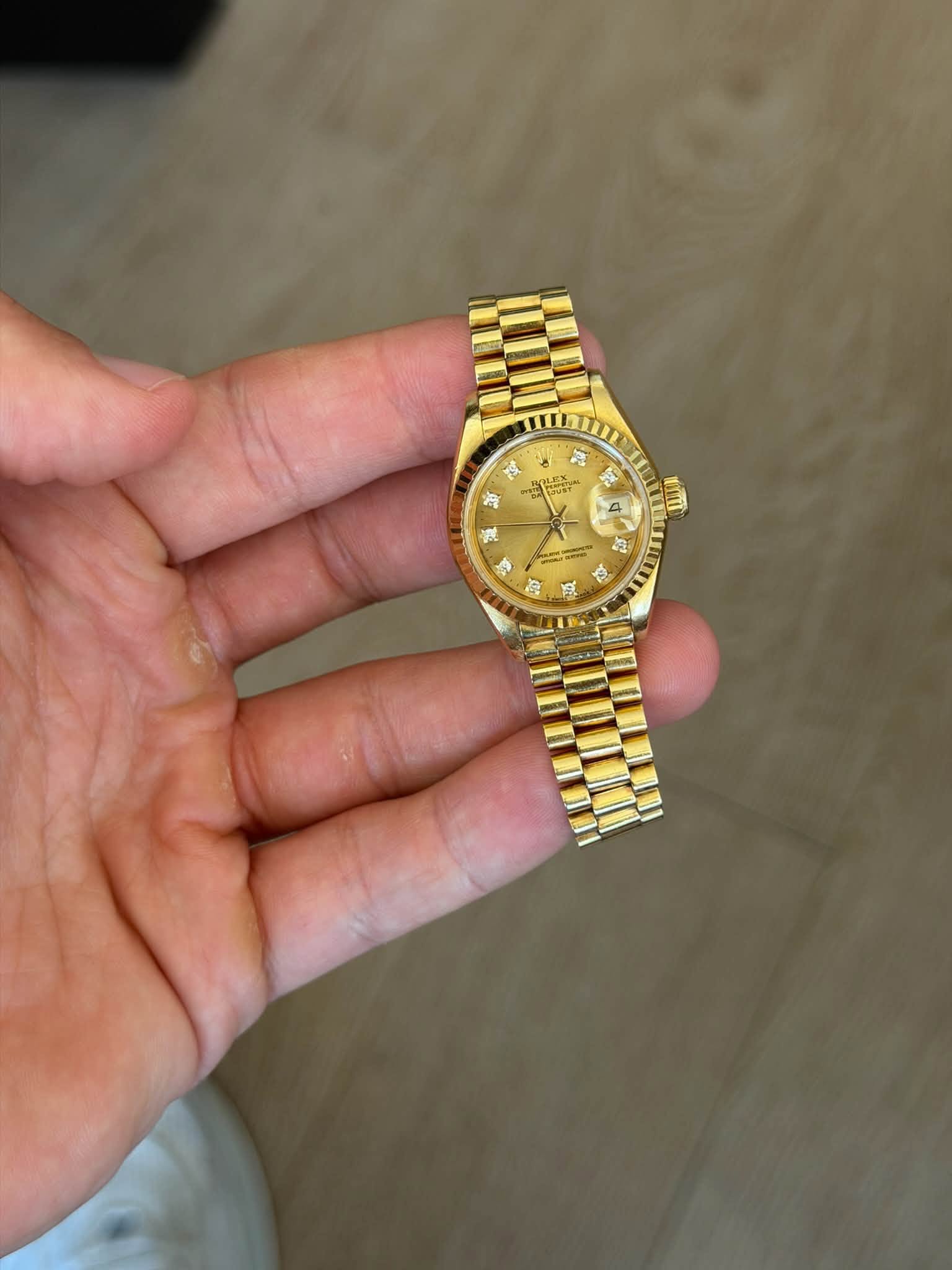 May be an image of wrist watch and text