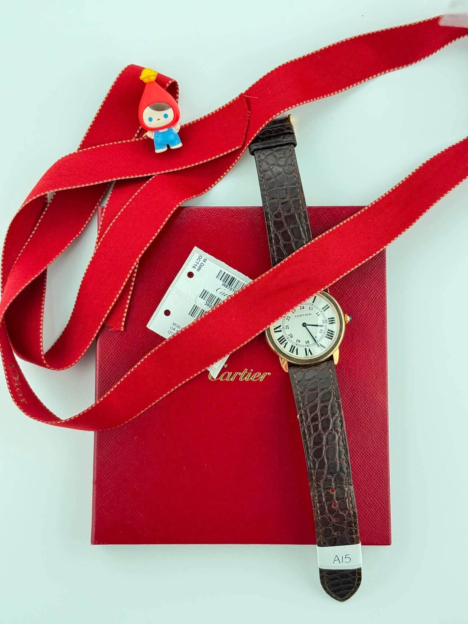 May be an image of saddle-stitched leather, wrist watch, leather and text