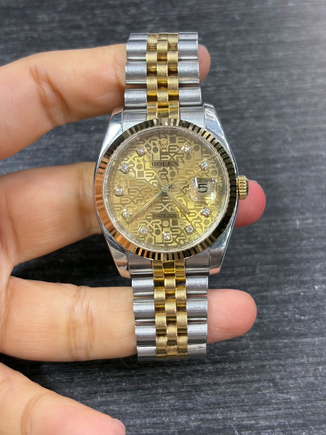 May be an image of wrist watch and text