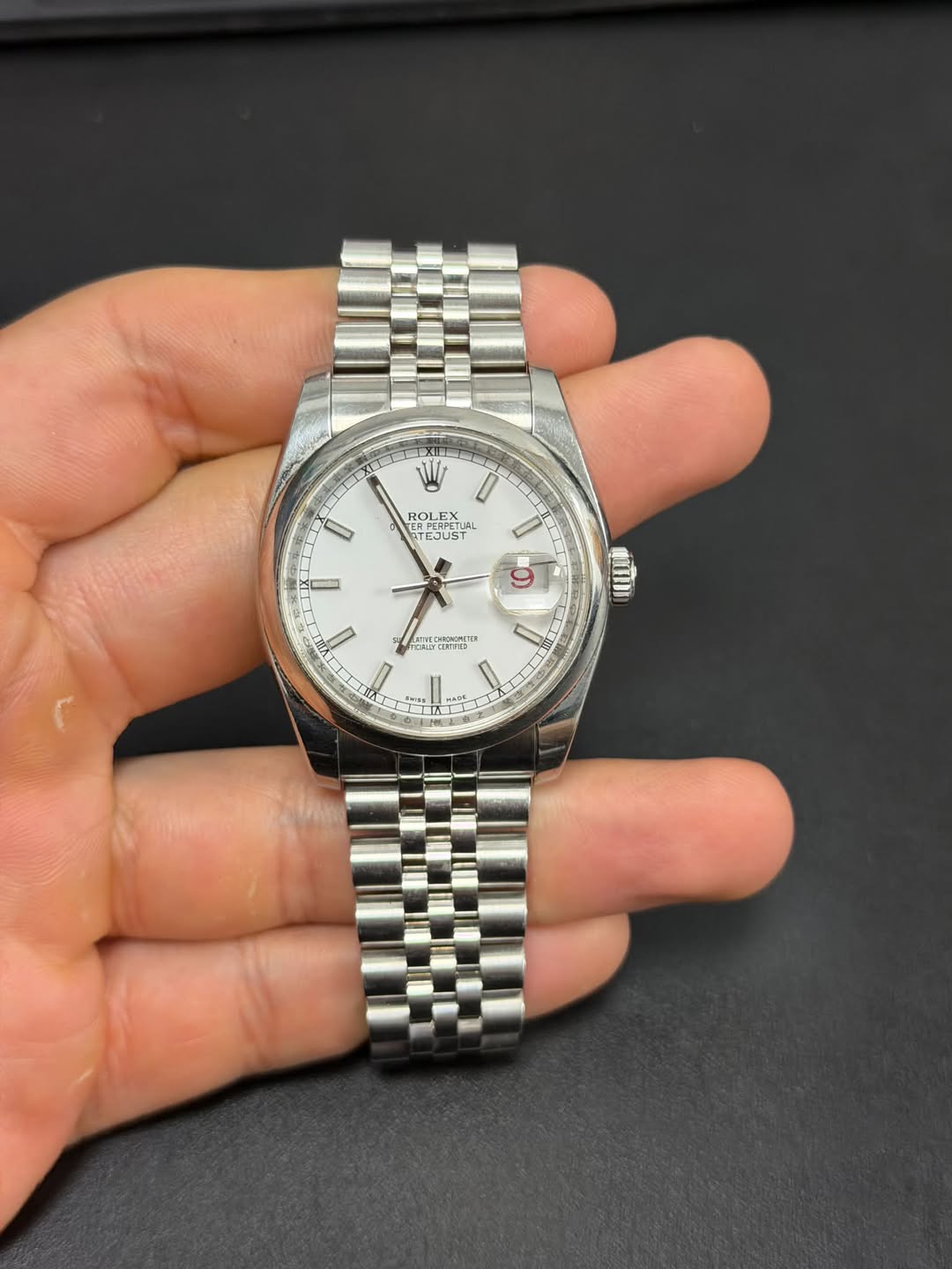 May be an image of wrist watch and text