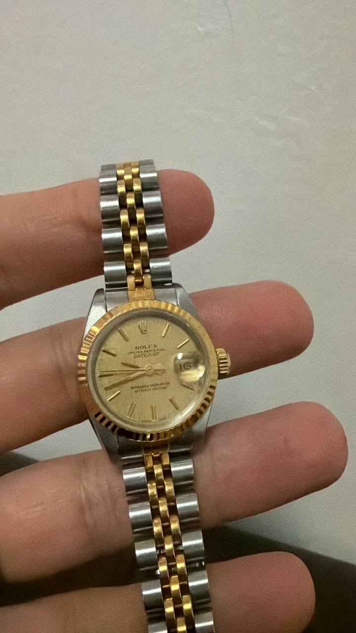 May be an image of wrist watch and text