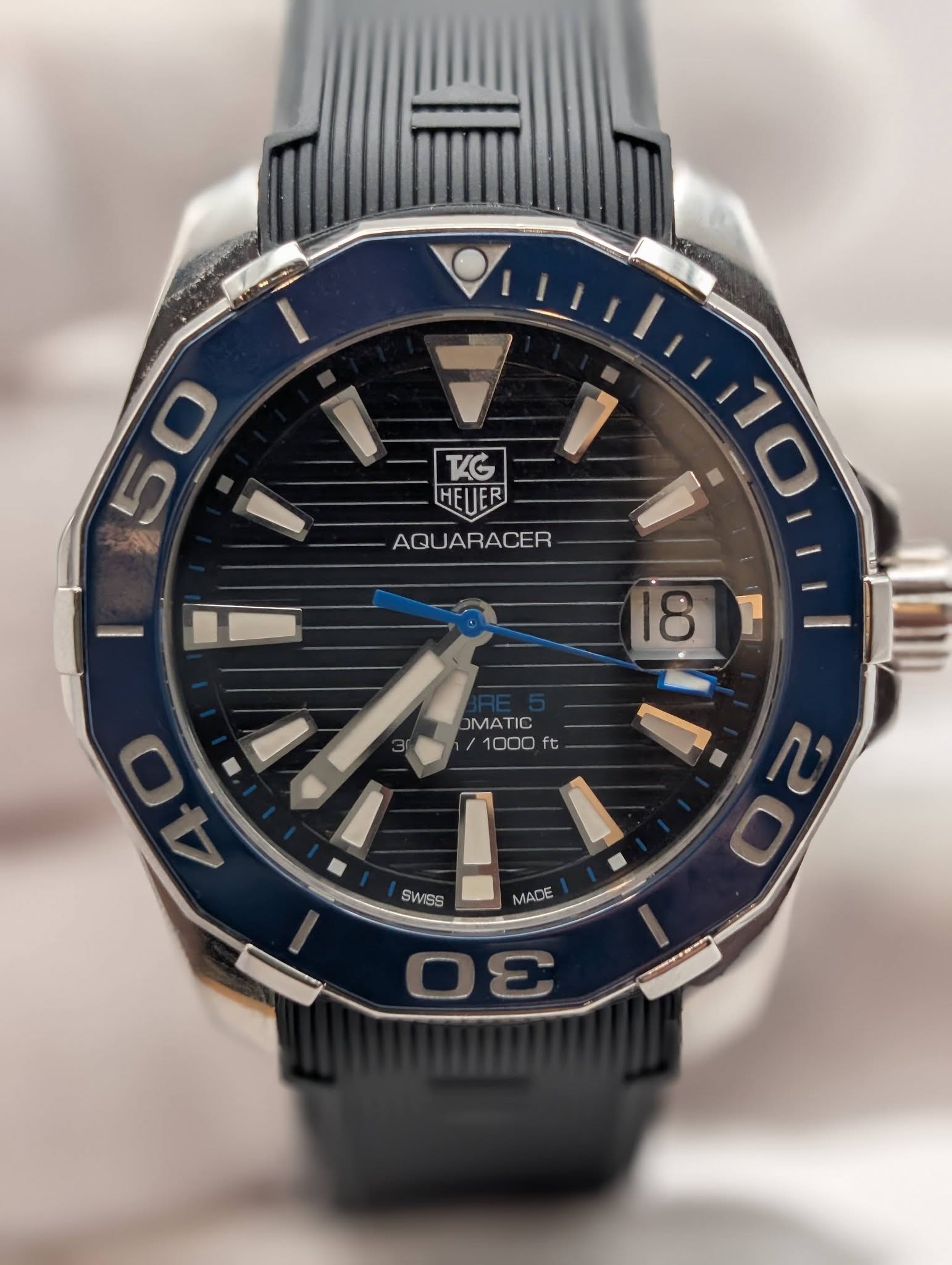 May be an image of wrist watch and text that says '5 50 0 TG HEUER HEUER AQUARACER ACER 180 18 7 OMATIO /1 1000 ft t SWSS MADE שם သ ผ'