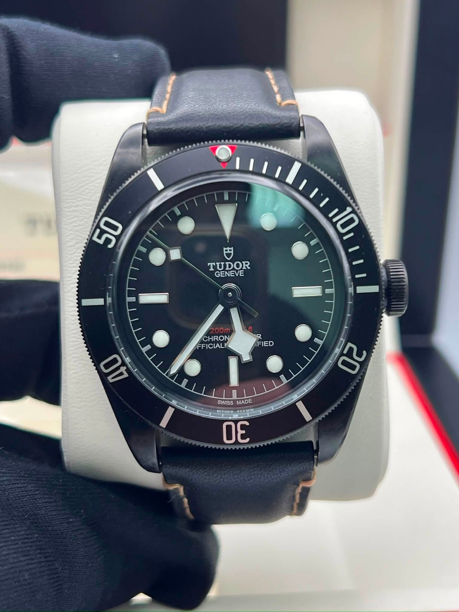 May be an image of wrist watch and text that says '50 つ TUDOR GENEVE 10 CHRON FFICIAL IED AO 백 20 SWISS S TADE MADE CU1Ss SS 30'