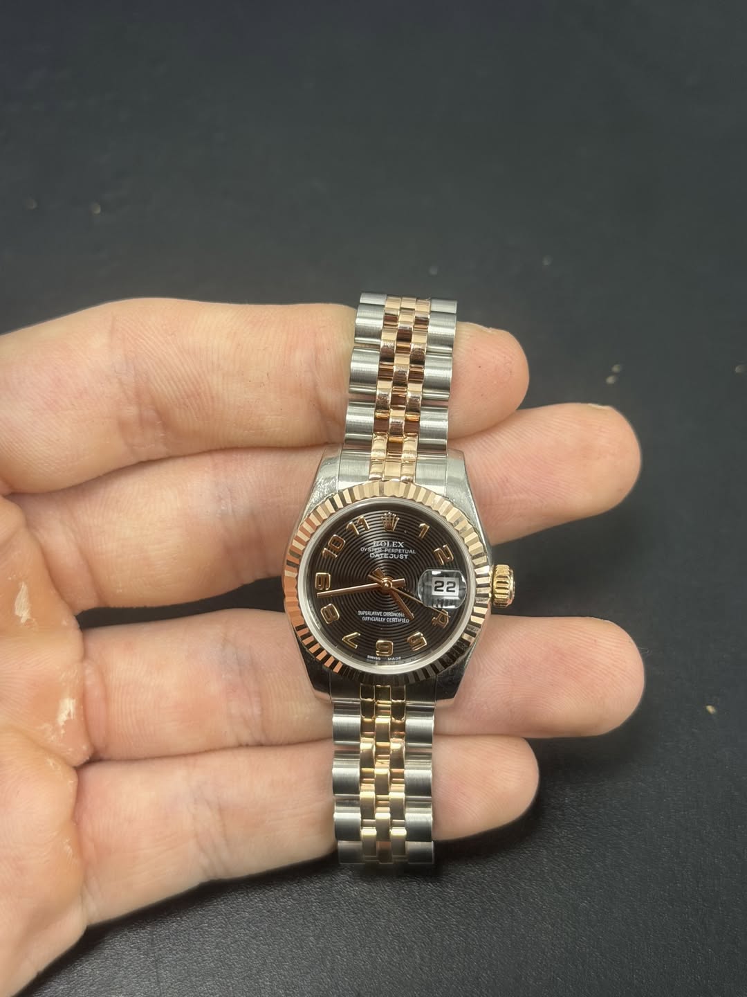May be an image of wrist watch and text