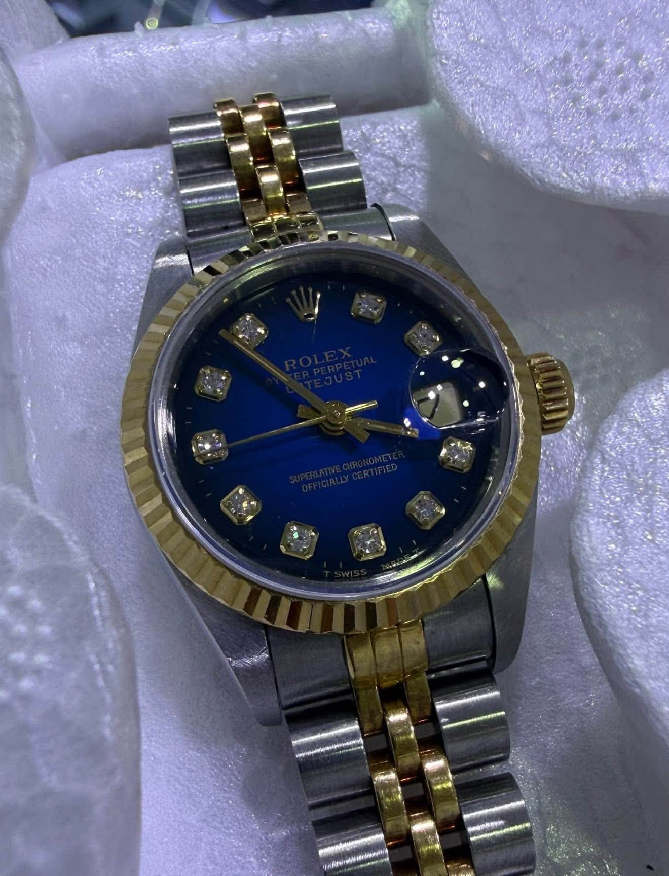 May be an image of wrist watch and text