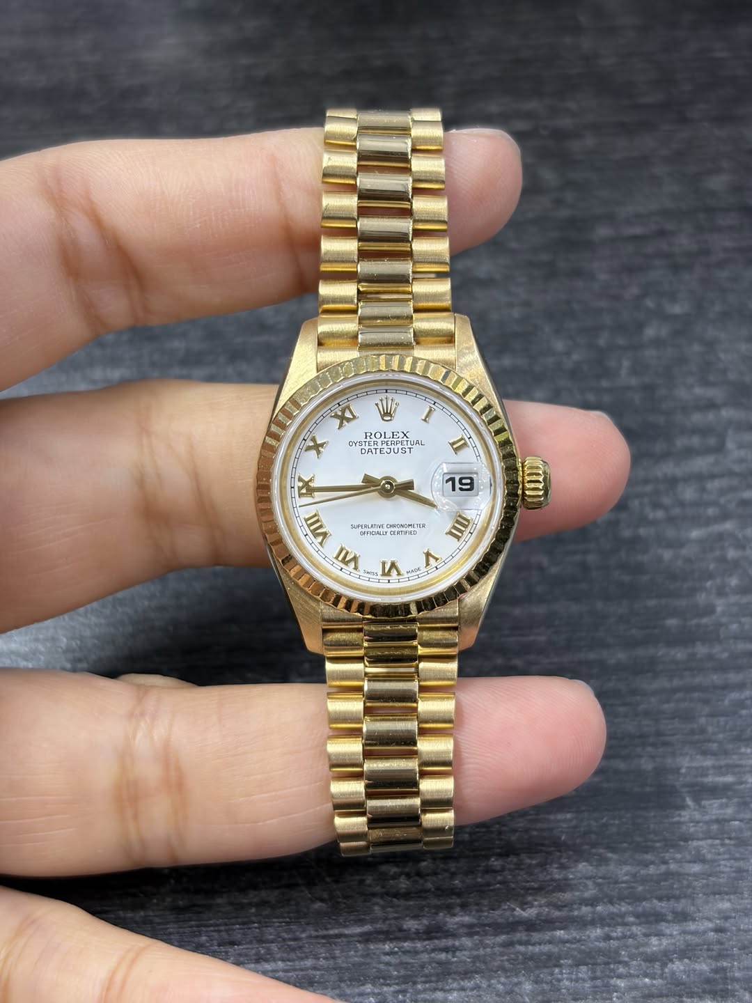 May be an image of wrist watch and text