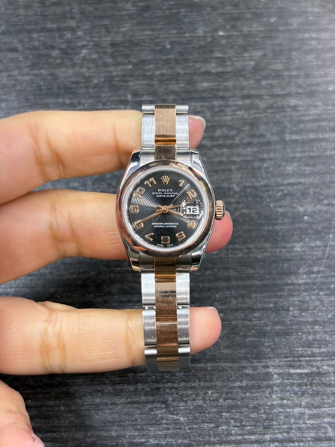 May be an image of wrist watch and text