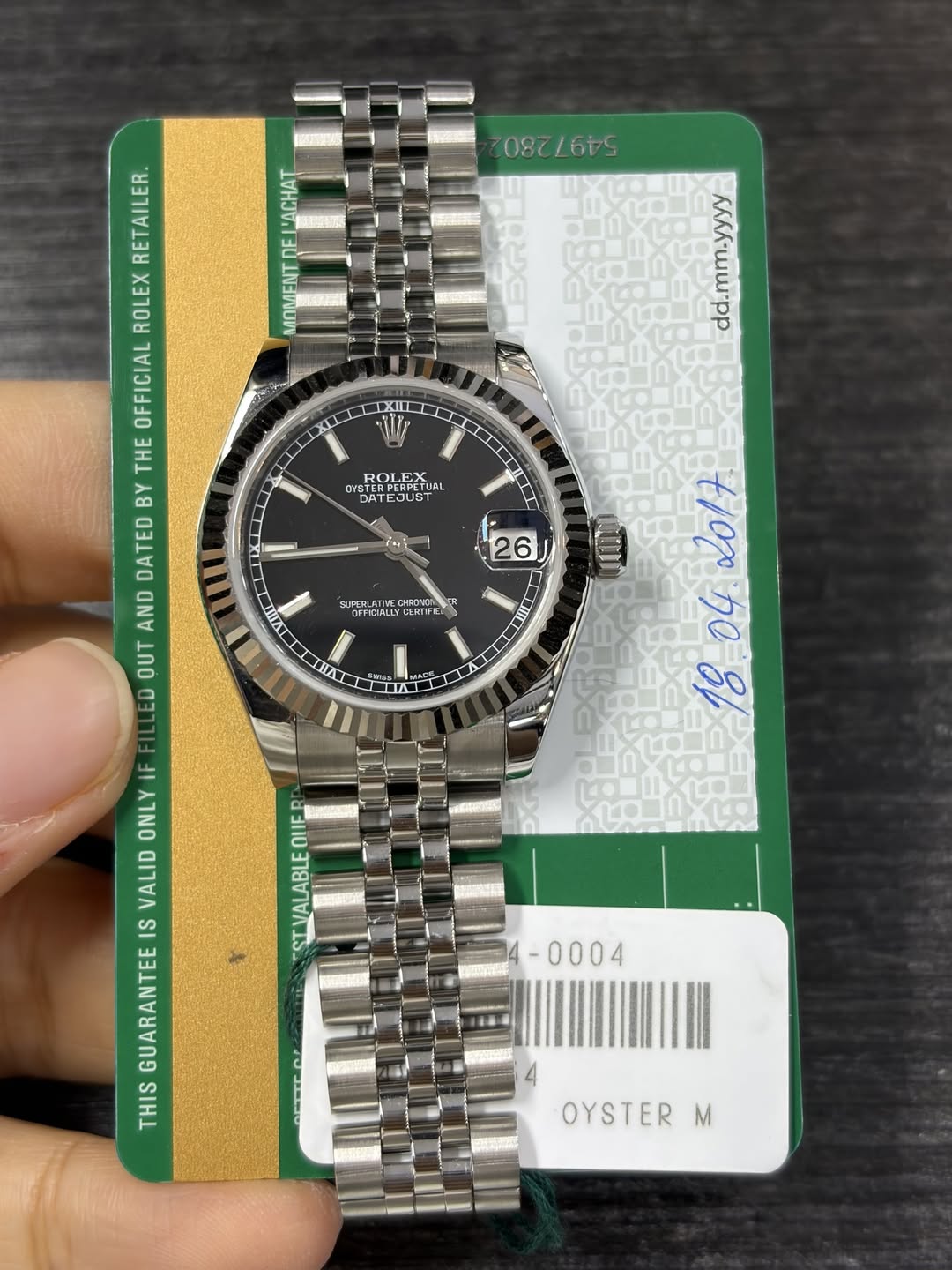 May be an image of wrist watch and text that says ' LACHAT MOMENT IXIL XILL u KЛAa•WWpp RETAILER. ROLEX EOFFICIA THE OFFICIAL BY DATED AND OUT ED ROL ROLEA TUAL OYSTER YSTER…