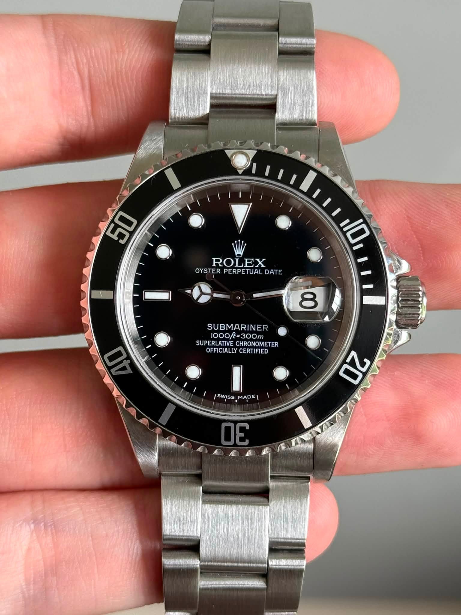 May be an image of wrist watch and text that says '50 ROLEX OYSTER PERPETUAL OYSTERPERPETUALDATE DAT 10 8 SUBMARINE NE 1000R 00f=300 300m SUPERLATIV SUPERLATIVECHRONOMETER…
