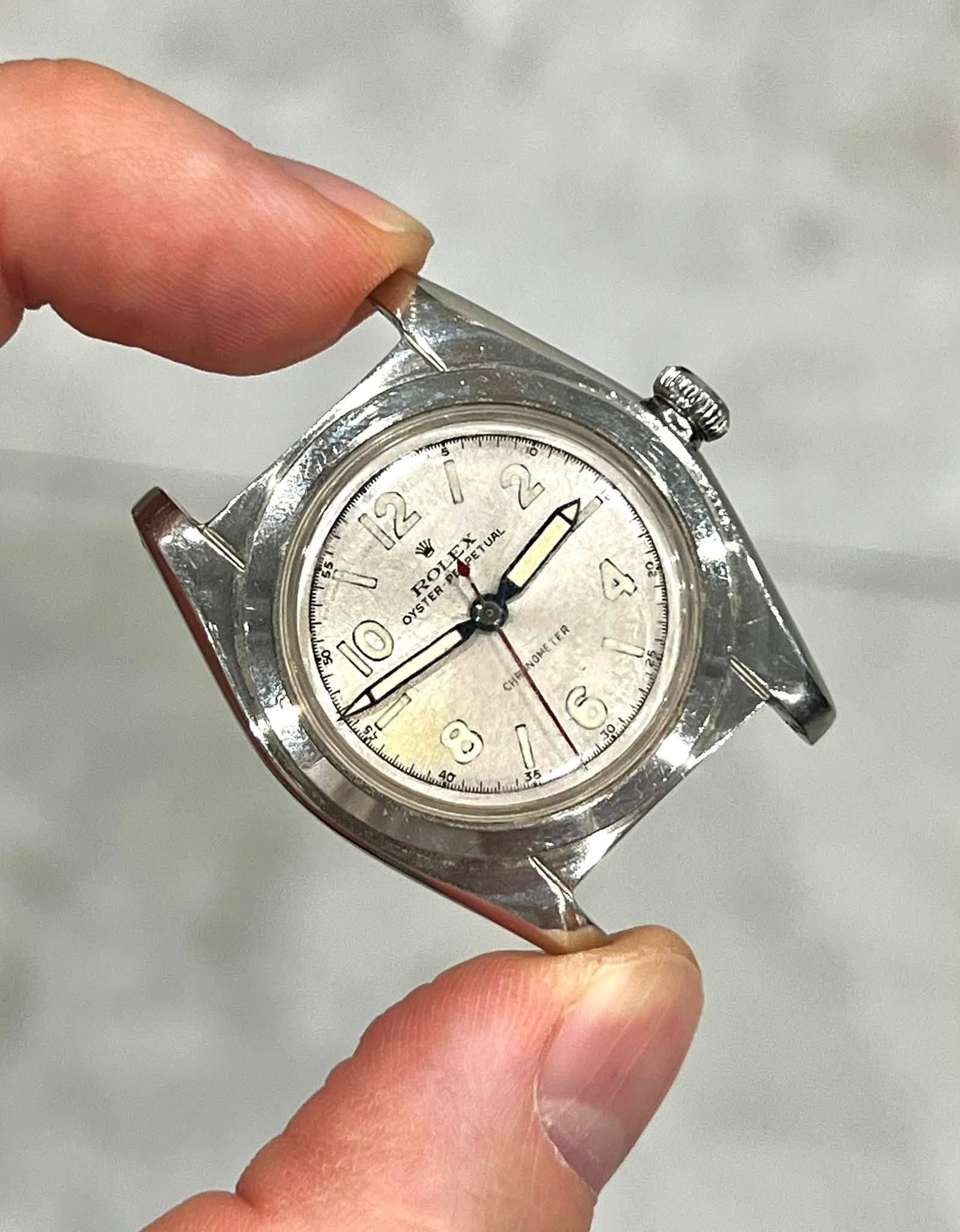 May be an image of wrist watch and text