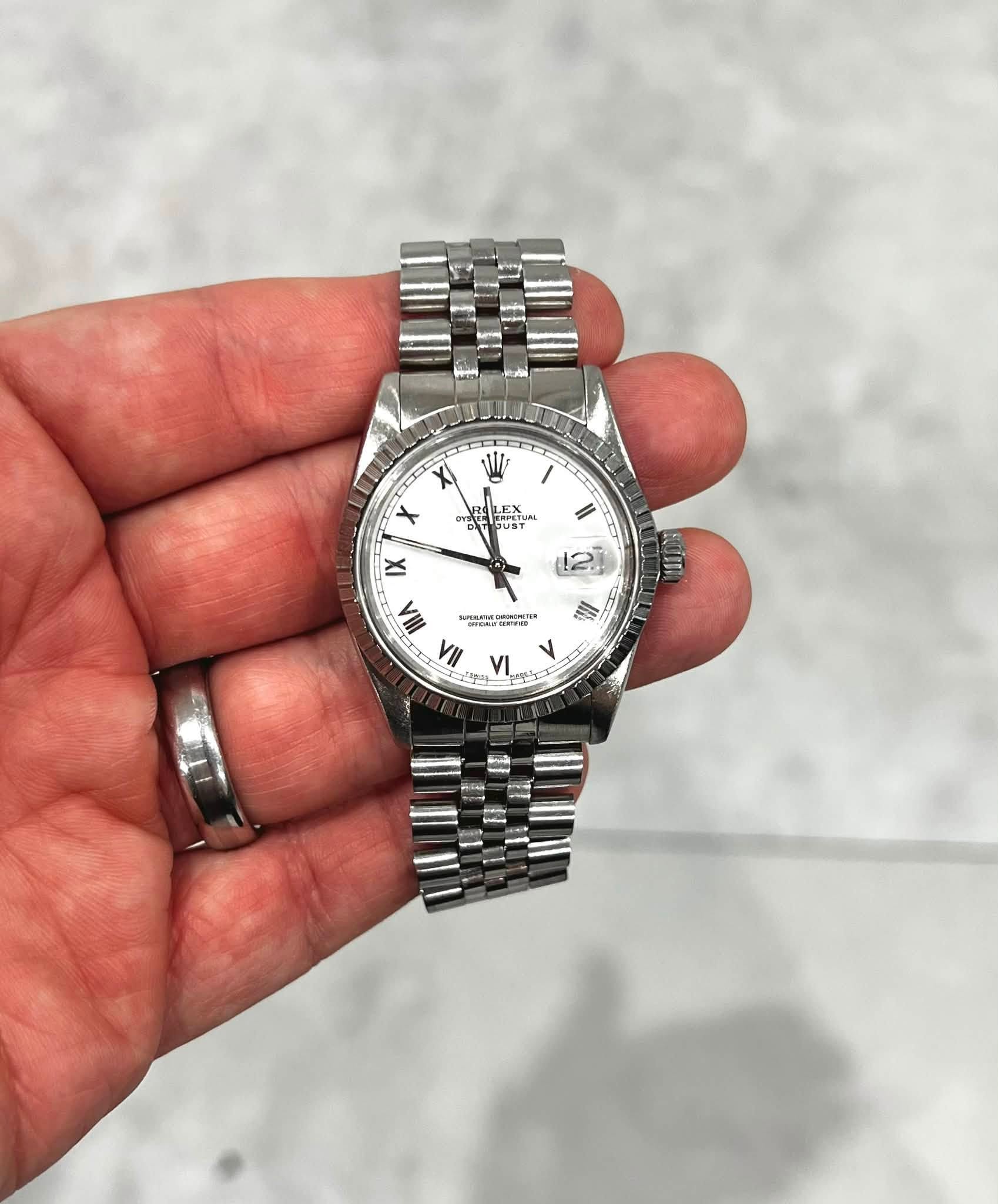 May be an image of wrist watch and text