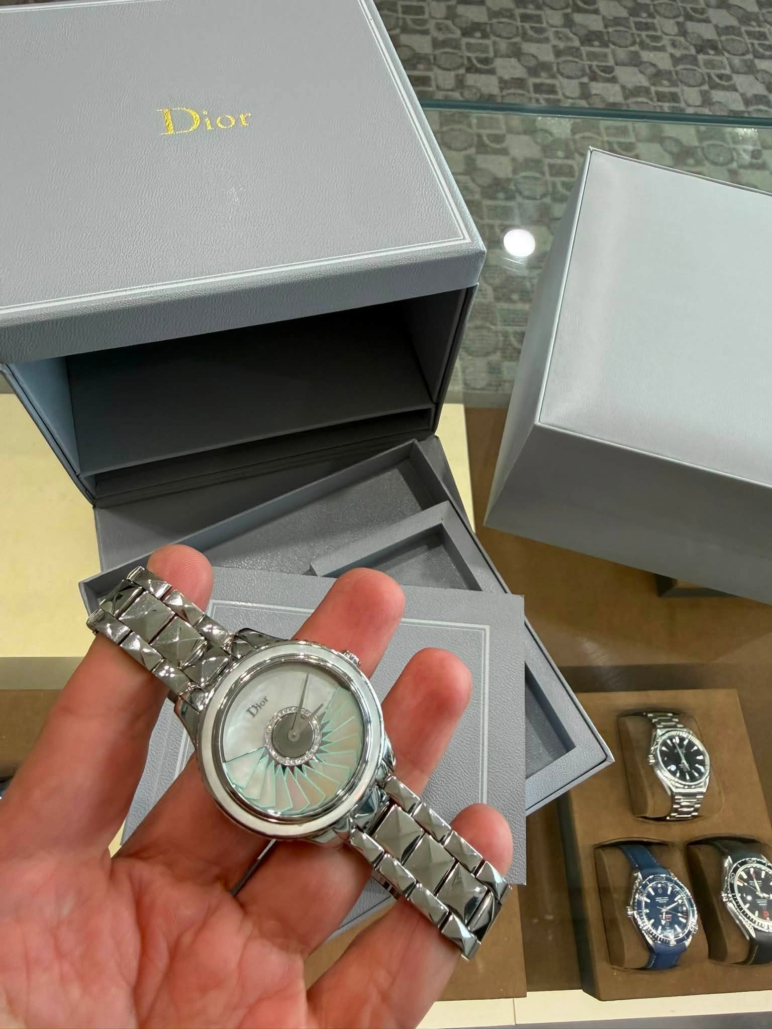 May be an image of ‎wrist watch and ‎text that says '‎Dior Dior اصت‎'‎‎
