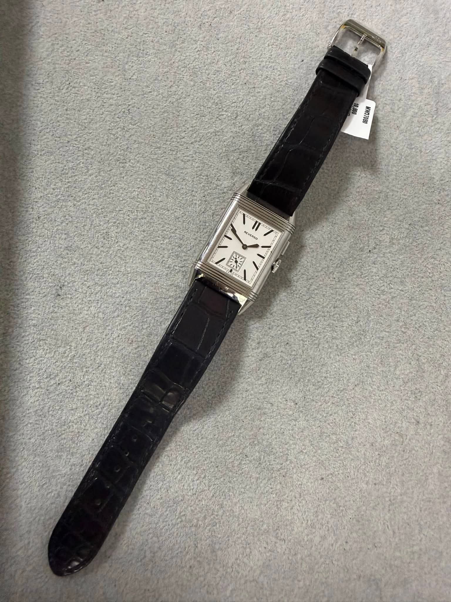 May be an image of leather, wrist watch and text