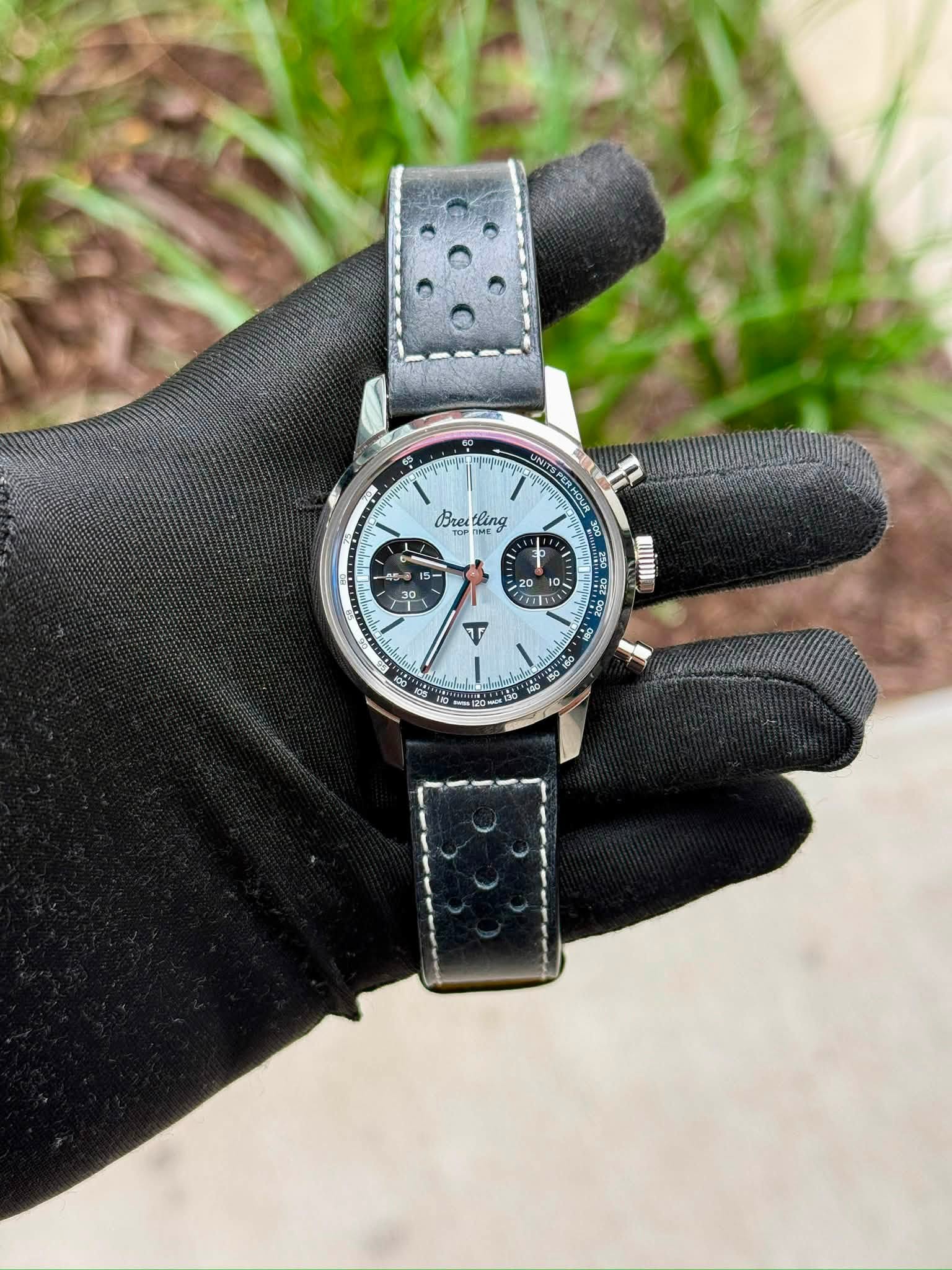 May be an image of wrist watch, leather and text