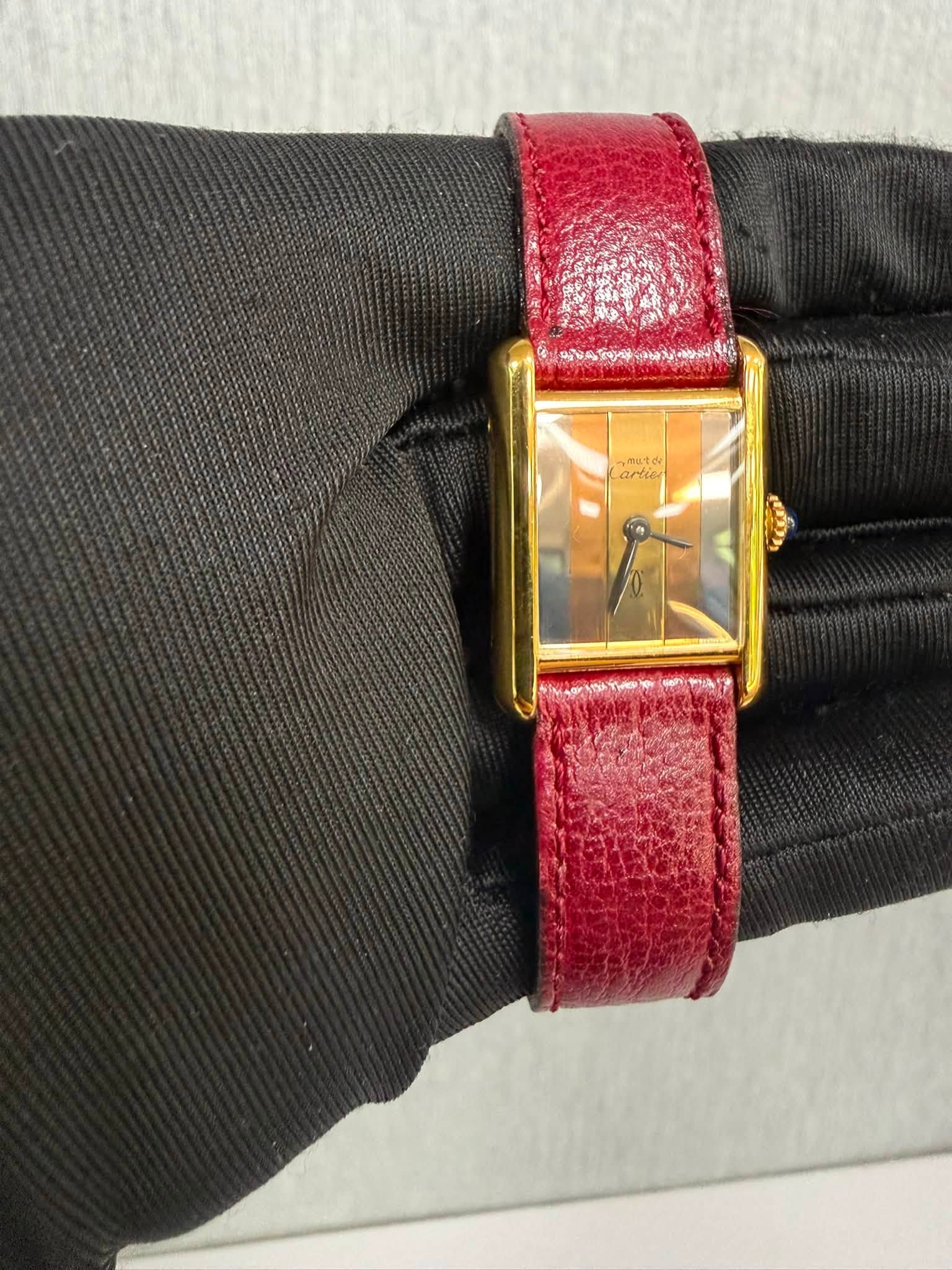 May be an image of leather, wrist watch and text