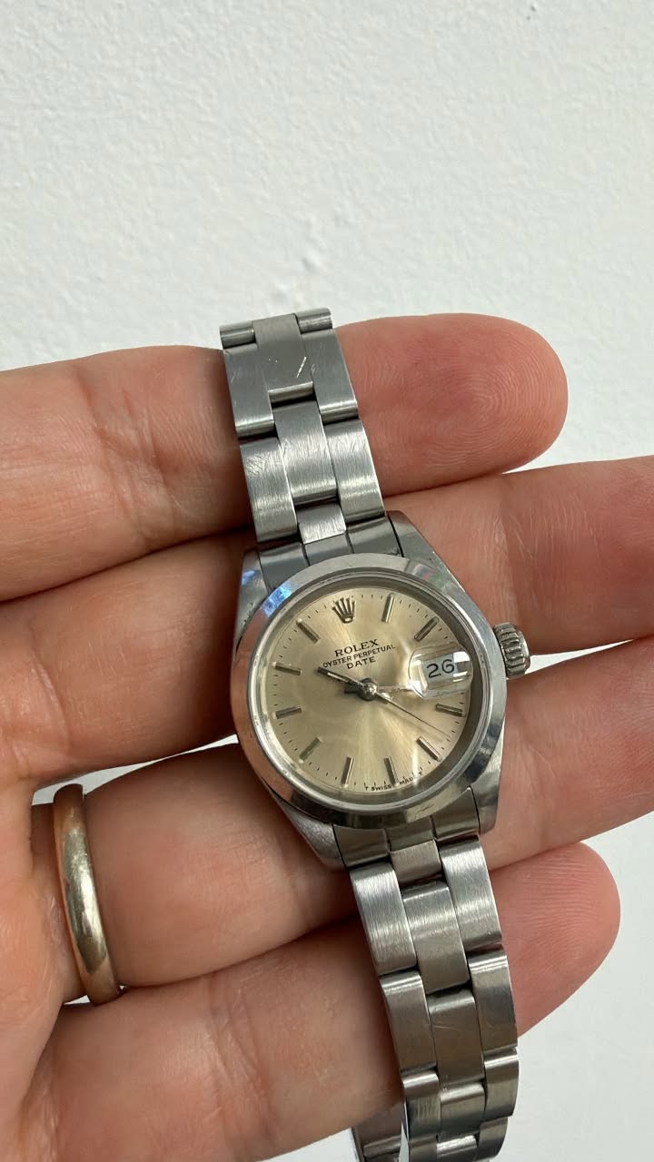 May be an image of wrist watch and text