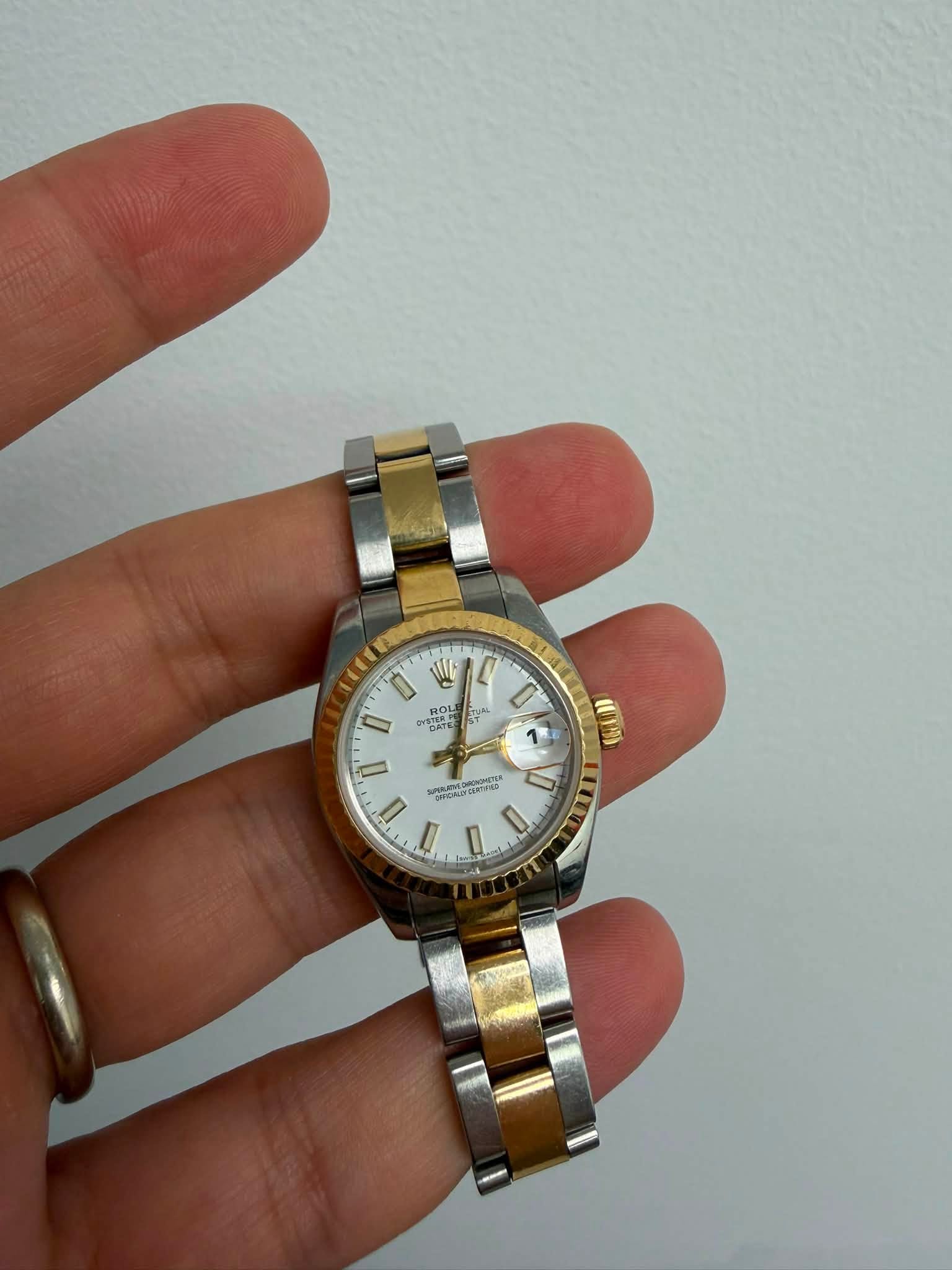 May be an image of wrist watch and text