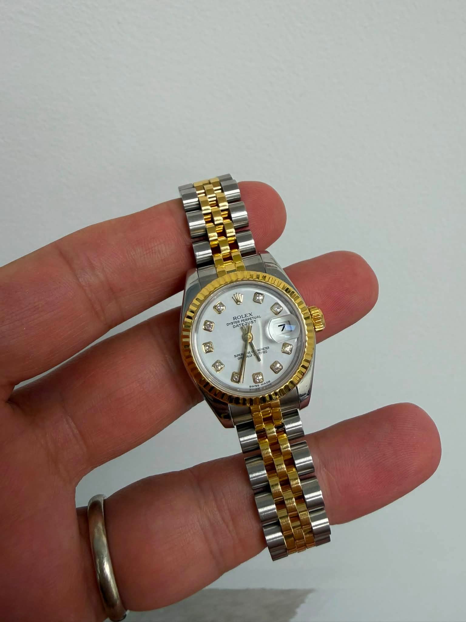 May be an image of wrist watch and text