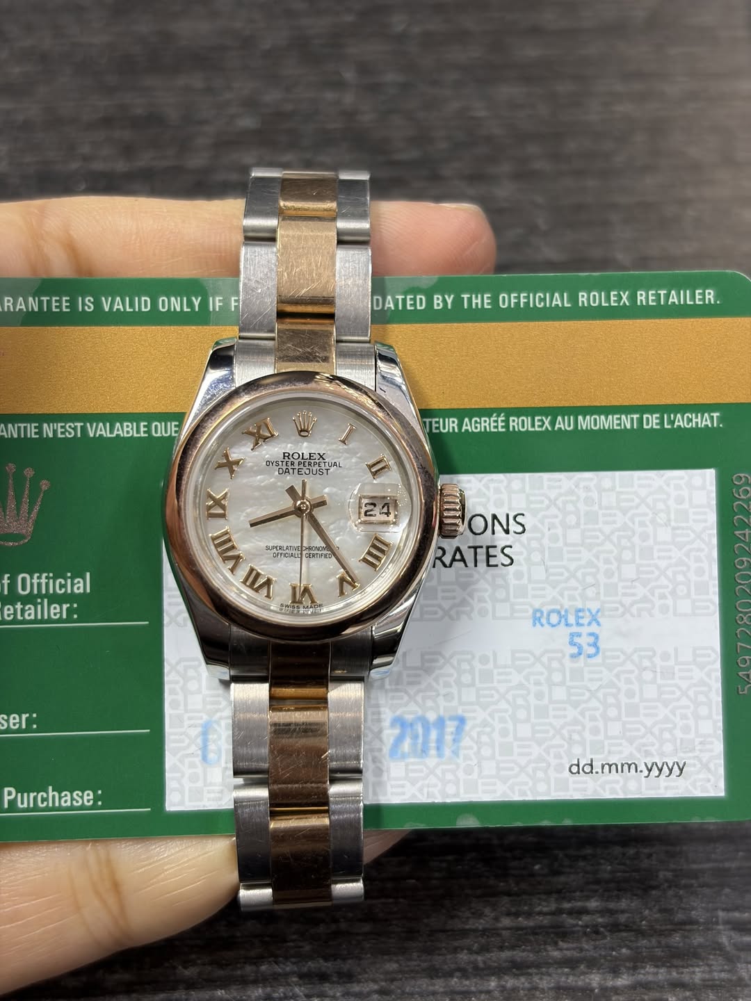 May be an image of wrist watch and text that says 'RANTEE IS VALID ONLY E IF F DATED BY THE OFFICIAL ROLEX RETAILER. ANTIEN'ESTVALABLEQUE ANTIE N'EST VALABLE QUE DATEJUST…