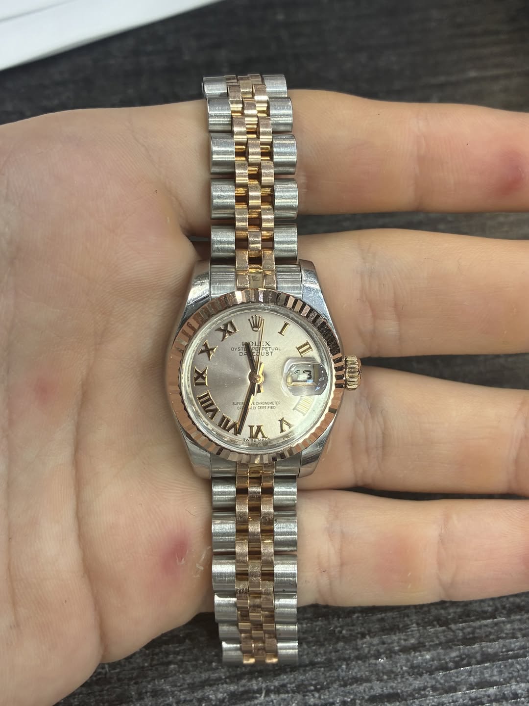May be an image of wrist watch and text