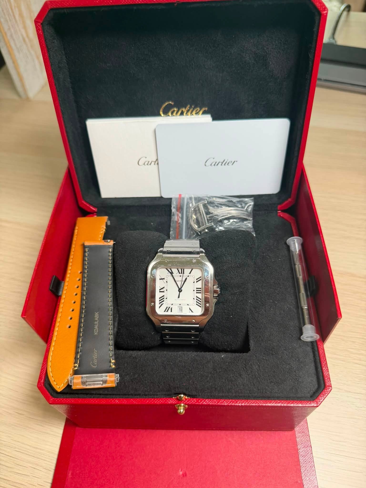 May be an image of digital watch and text that says 'Cartier Car Cara Crtier سس = I //1 KDAULABK Cartier'