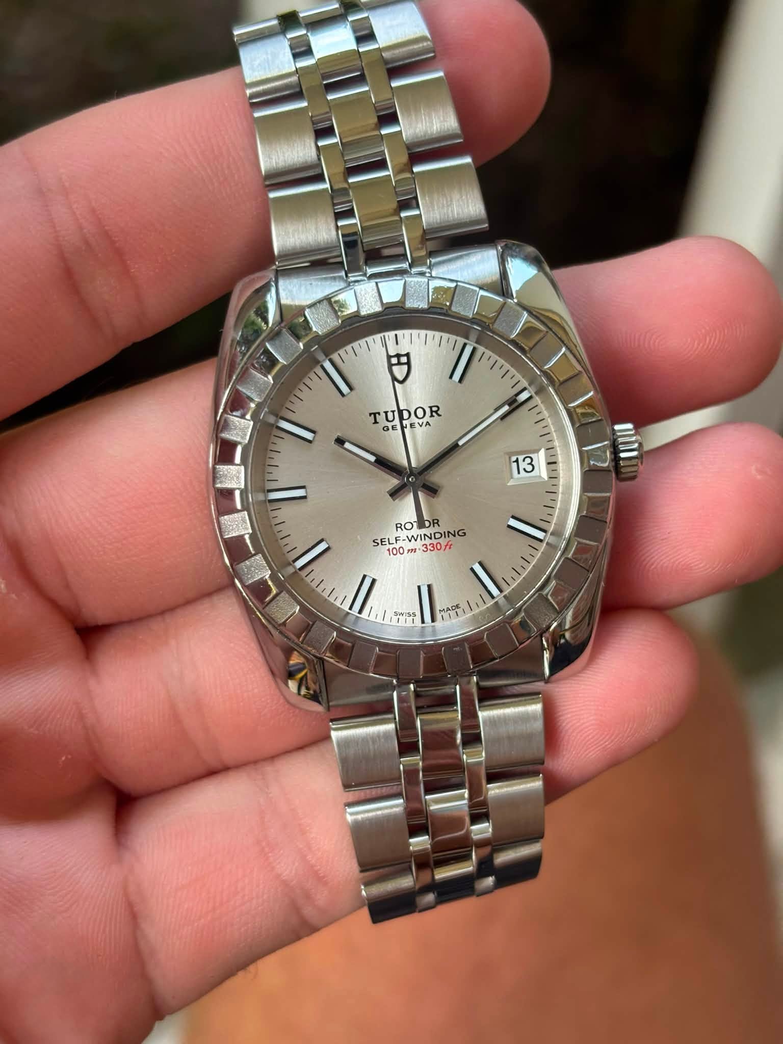 May be an image of wrist watch and text that says 'יויוין 円 ידי זיויו TUDOR TU GE GETEY PESA EVA VA 13 12 BOI GWINDING ROT ROTDR SELF-W WINDING 100 330/t ויויוי ויוין קיויו ললান…